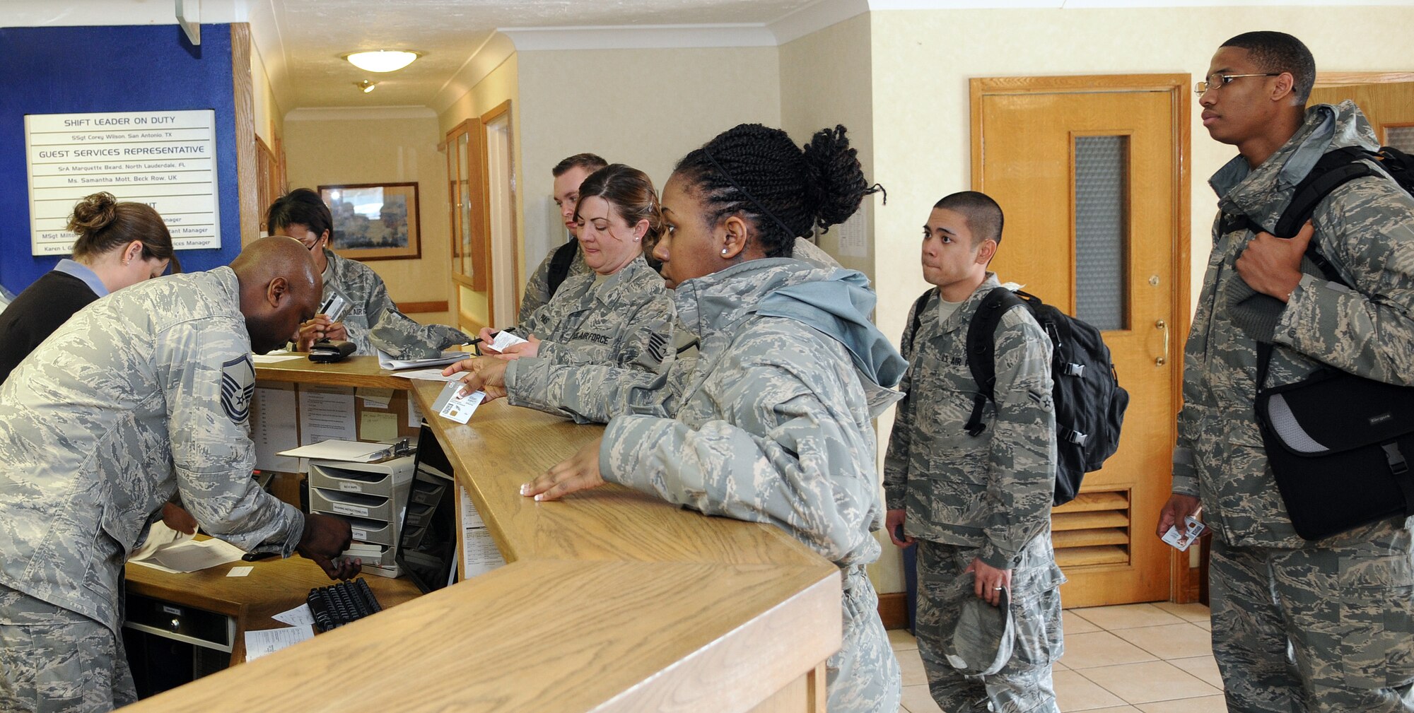 RAF MILDENHALL, England -- Customers are checked in at the Gateway Inn here by Master Sgt. Milton Erkins, 100th Force Support Squadron, April 6. The lodging office runs 318 rooms with 65 staff members to provide services for active duty personnel, civilians and space available travelers either on base or in one of 13 contracted businesses. (U.S. Air Force photo/Staff Sgt. Thomas Trower)