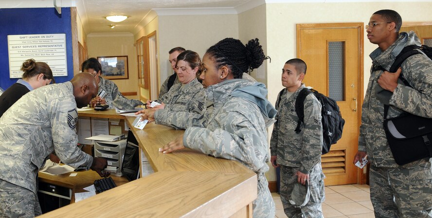 RAF MILDENHALL, England -- Customers are checked in at the Gateway Inn here by Master Sgt. Milton Erkins, 100th Force Support Squadron, April 6. The lodging office runs 318 rooms with 65 staff members to provide services for active duty personnel, civilians and space available travelers either on base or in one of 13 contracted businesses. (U.S. Air Force photo/Staff Sgt. Thomas Trower)