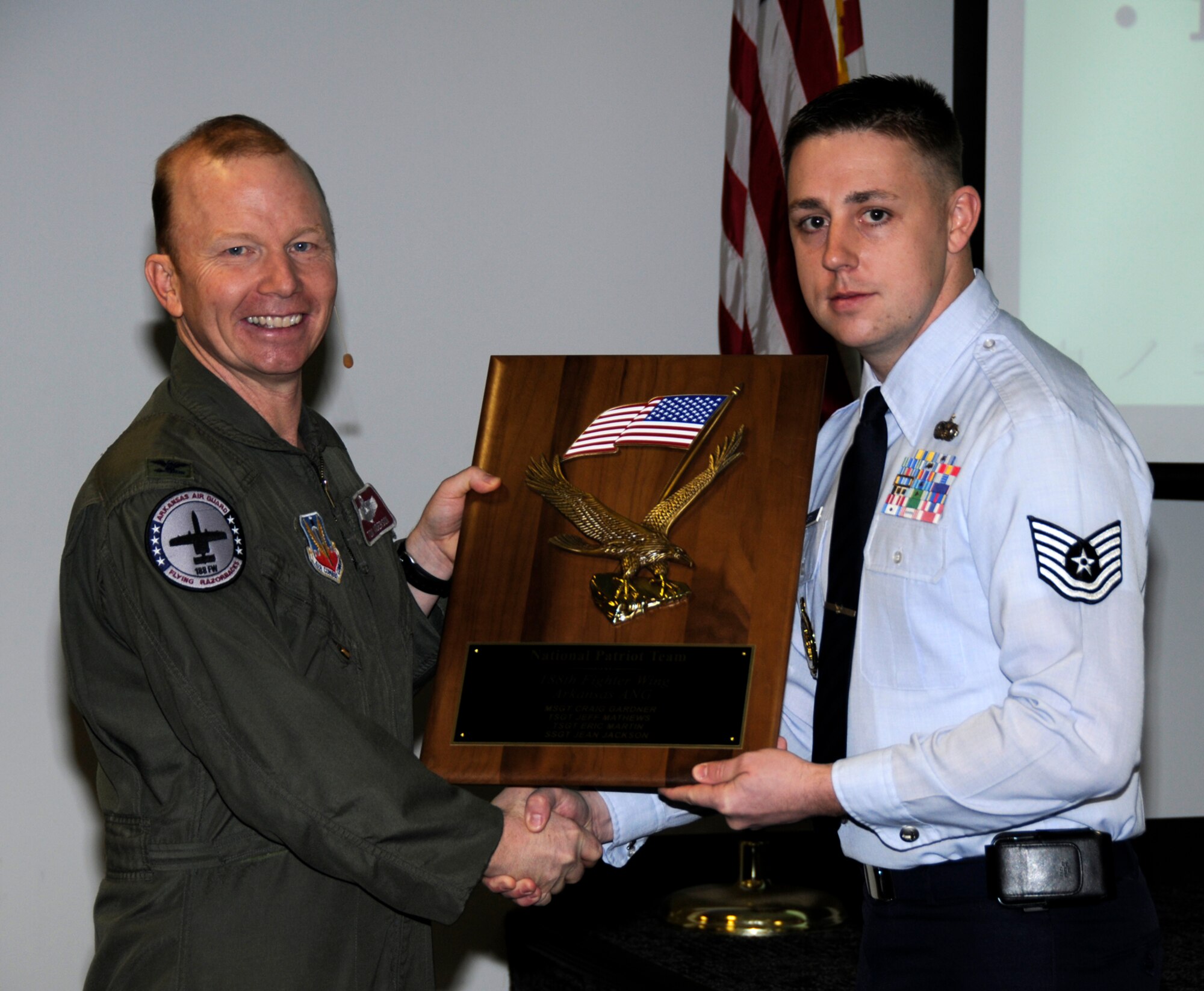 Tech Sgt. Eric Martin, right, poses with Col. Tom Anderson, 188th Fighter Wing commander, at Commander's Call with the Patriot Team Award, which the 188th Fighter Wing Recruiting Office won for being named the Air National Guard's top recruiting office nationally for fiscal year 2009. The office received the Patriot Team Award at the ANG's annual Recruiting and Retention banquet held in Dallas, Feb. 23. (U.S. Air Force photo by Tech Sgt. Stephen Hornsey/188th Fighter Wing Public Affairs)

