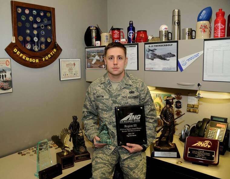 Tech Sgt. Eric Martin, 188th Fighter Wing recruiter, poses in his office with several of his national, state and regional awards received in 2009 and 2010.  Martin was named the Rookie Production Recruiter of the Year at the national level for FY 2009 at the Air National Guard's annual Recruiting and Retention awards banquet held in Dallas, Feb. 23. (U.S. Air Force photo by Senior Master Sgt. Dennis Brambl/188th Fighter Wing Public Affairs)

