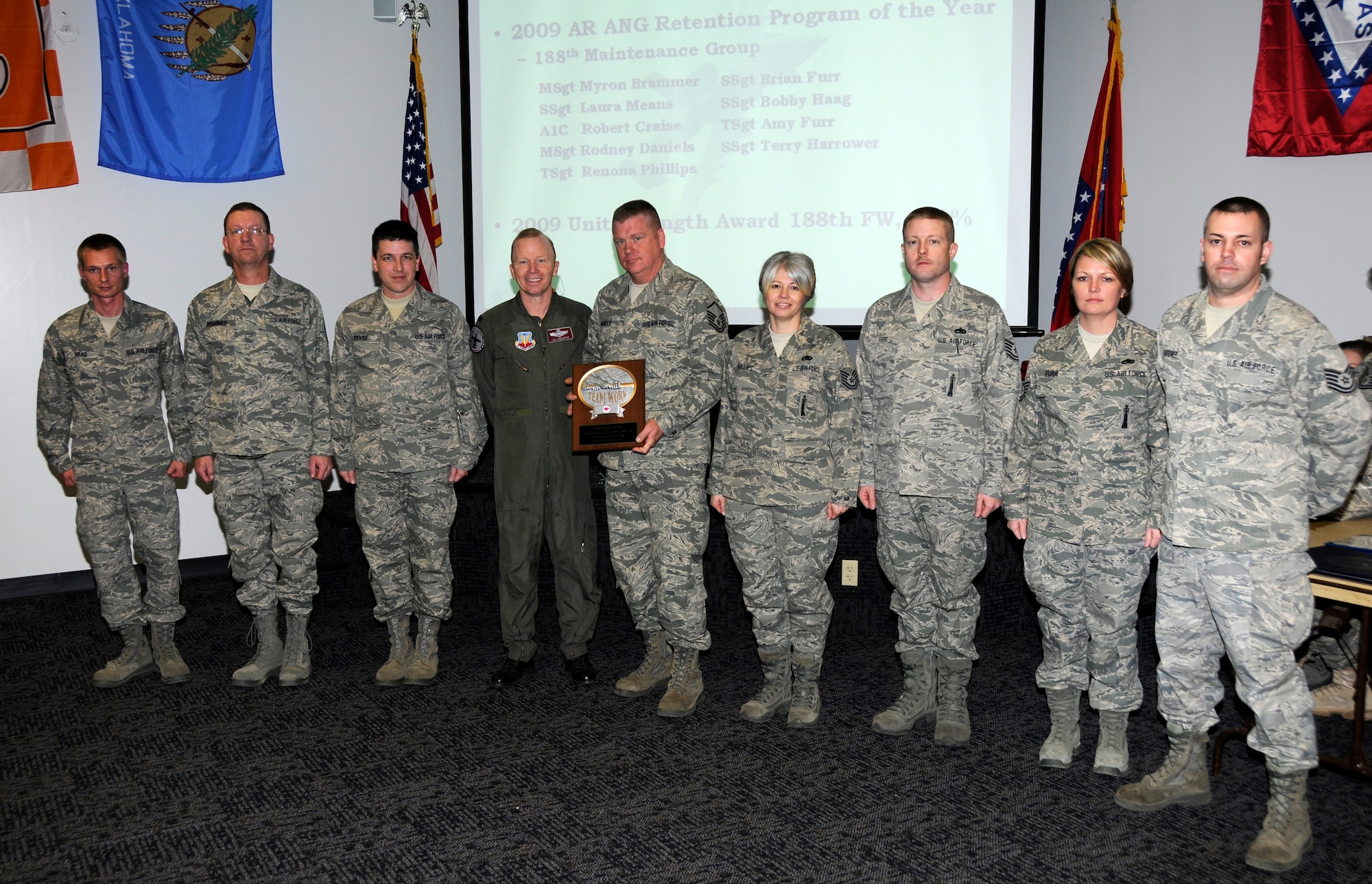 From left: Staff Sgt. Bobby Haag, Master Sgt. Myron Brammer,  Airman 1st Class Robert Craise, Col. Tom Anderson, 188th Fighter Wing commander, Master Sgt. Rodney Daniels, Tech Sgt. Renona Phillips, Staff Sgt. Brian Furr, Tech Sgt. Amy Furr and Tech Sgt. Terry Harrower. Not pictured: Staff Sgt. Alicia Peters, Tech Sgt. Brian Anible, Tech Sgt. Lonnie Nicholson, Master Sgt. Robert Grimm and Staff Sgt. Laura Means. Selected members of the 188th Maintenance Group were honored for their retention program at Commander's Call March 6. The Guardsmen were identified as the catalyst for the high retention within the group. Members also received a coin from Col. Anderson and were recognized during the awards ceremony at Commander's Call. (U.S. Air Force photo by Tech Sgt. Stephen Hornsey/188th Fighter Wing Public Affairs)
