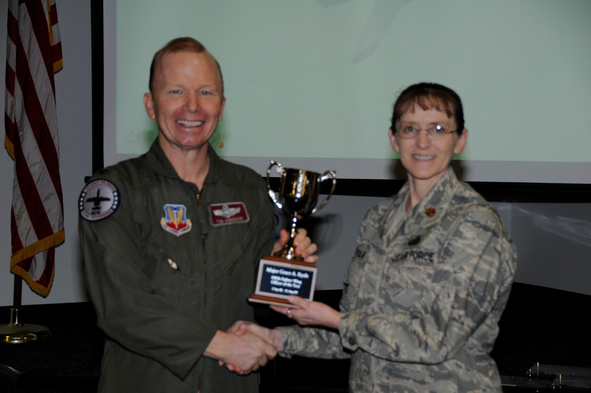Maj. Grace Ryals, right, accepts the Officer of the Year Award from Col. Tom Anderson, 188th Fighter Wing commander, during the unit's annual awards assembly at Commander's Call March 6. (U.S. Air Force photo by Tech Sgt. Stephen Hornsey/188th Fighter Wing Public Affairs)
