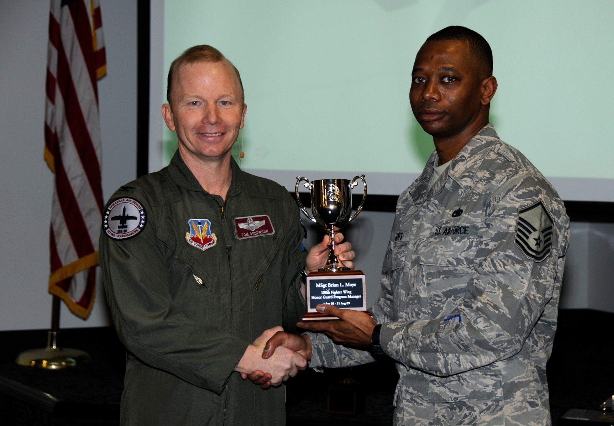 Master Sgt. Bryan Mays, right, accepts the Honor Guard Program Manager of the Year Award from Col. Tom Anderson, 188th Fighter Wing commander, during the unit's annual awards assembly at Commander's Call March 6. Mays also won the same award at the state level. (U.S. Air Force photo by Tech Sgt. Stephen Hornsey/188th Fighter Wing Public Affairs)
