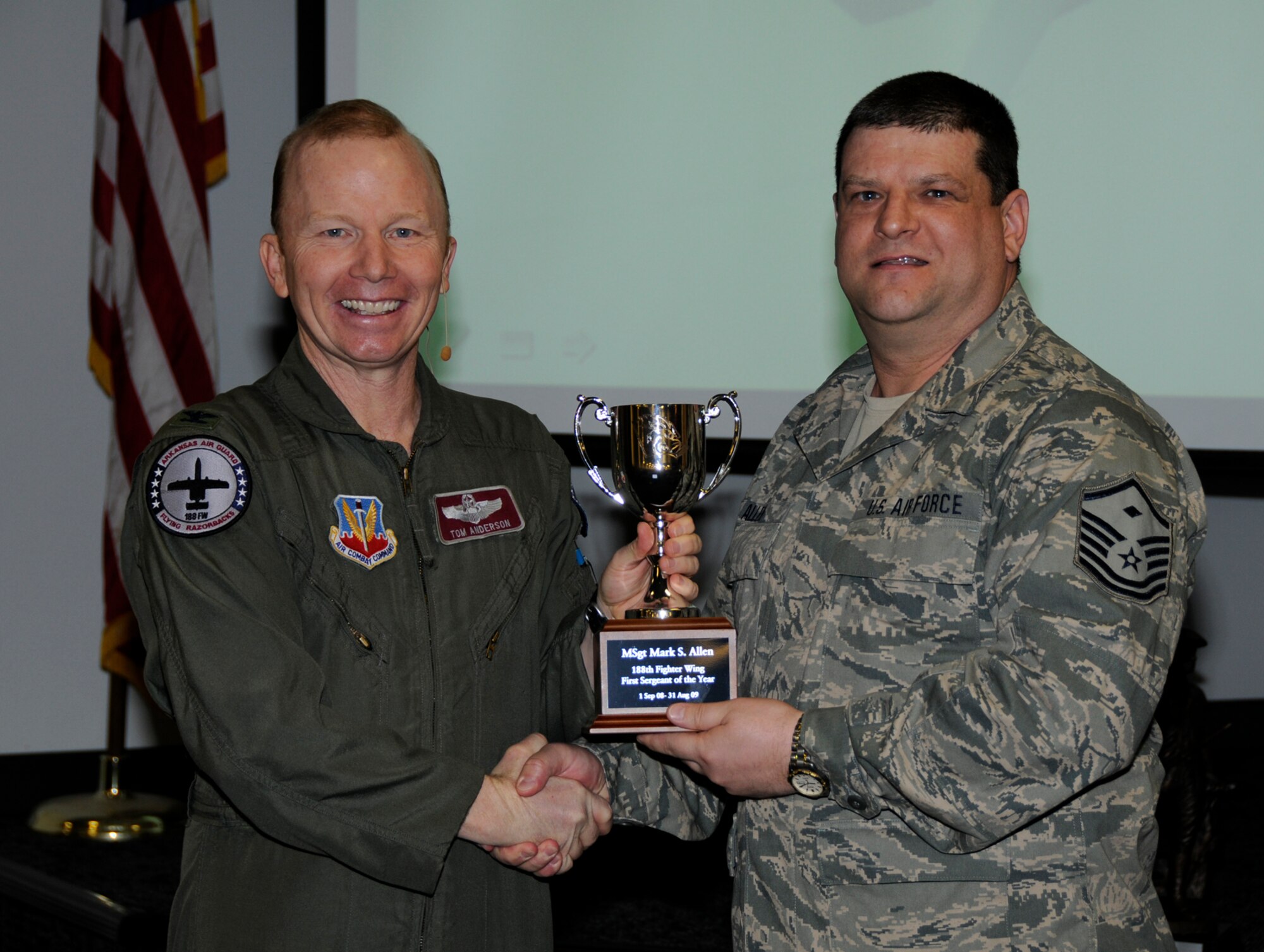Master Sgt. Mark Allen, right, accepts the First Sgt. of the Year Award from Col. Tom Anderson, 188th Fighter Wing commander, during the unit's annual awards assembly at Commander's Call March 6. (U.S. Air Force photo by Tech Sgt. Stephen Hornsey/188th Fighter Wing Public Affairs)
