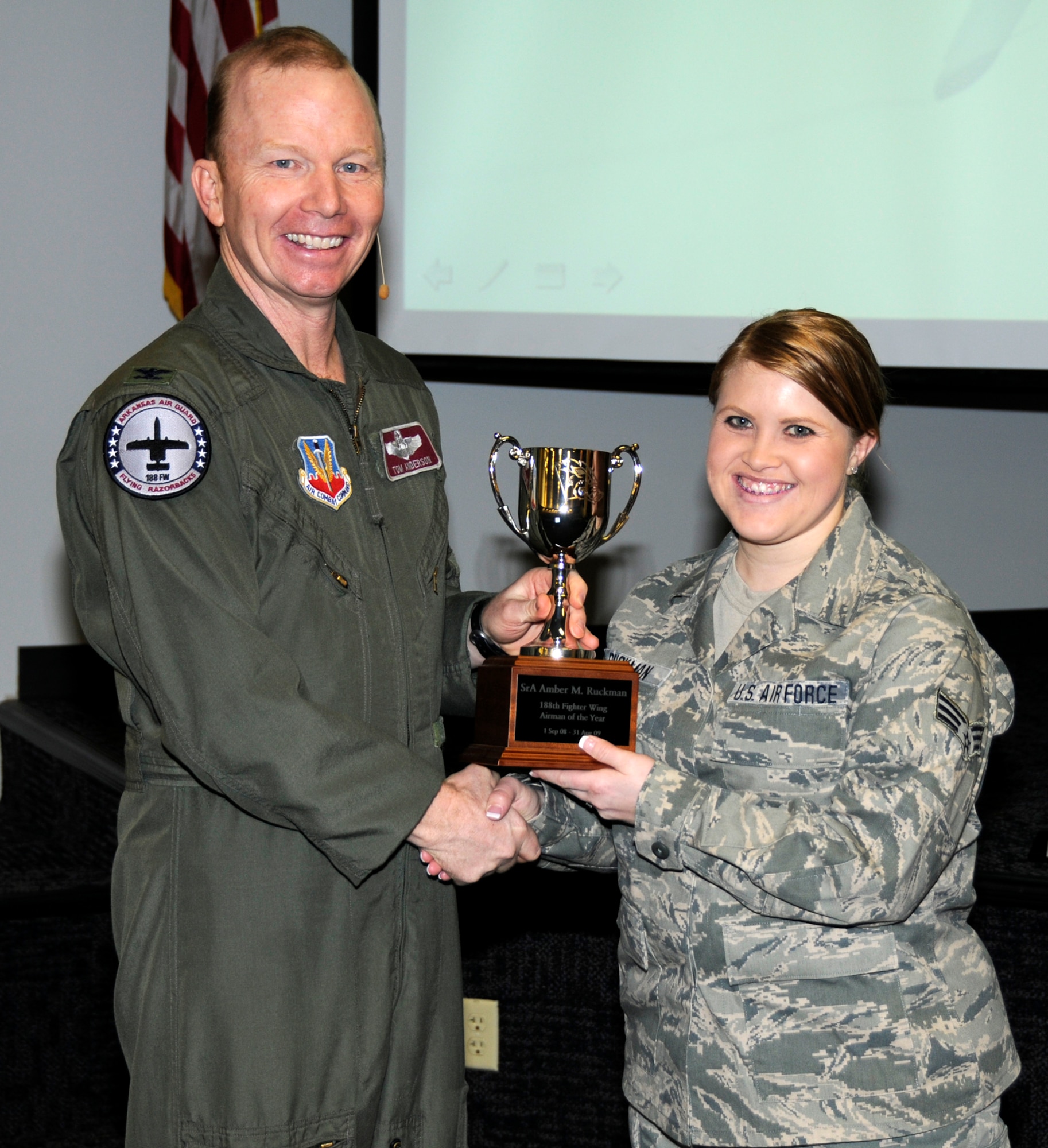 Senior Airman Amber M. Ruckman, right, accepts the Airman of the Year Award from Col. Tom Anderson, 188th Fighter Wing commander, during the unit's annual awards assembly at Commander's Call March 6.  (U.S. Air Force photo by Tech Sgt. Stephen Hornsey/188th Fighter Wing Public Affairs)
