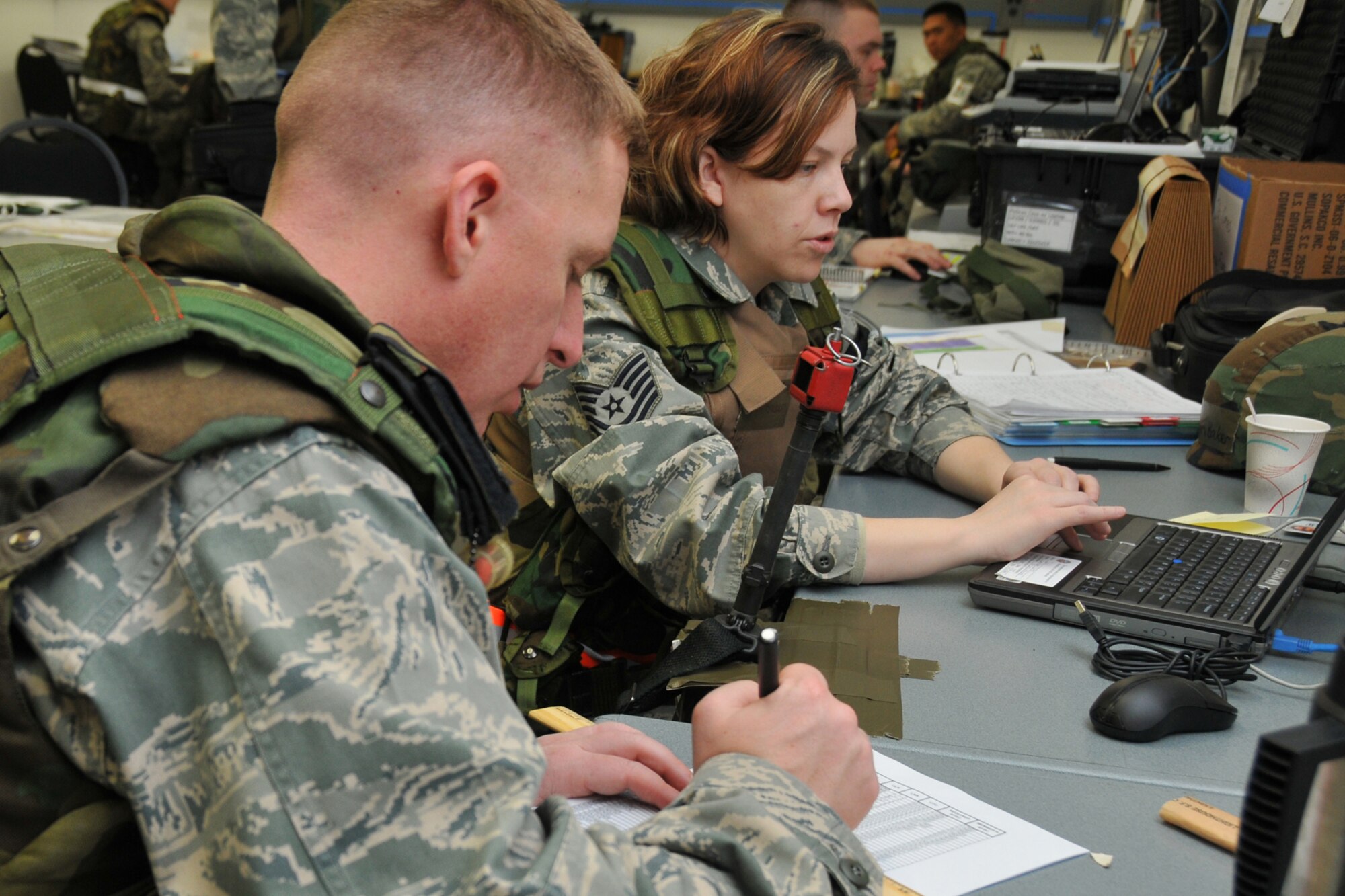 VOLK FIELD ANGB, Wisc., --  1st Lt. Chris Tusing and Tech. Sgt. Erin Baker work cargo movement plans during an operational readiness inspection. Reservists from Grissom and Guardsmen from Martinsburg, W.V., worked together during the operational readiness inspection.  (U.S. Air Force photo/Master Sergeant Emily Beightol-Deyerle)