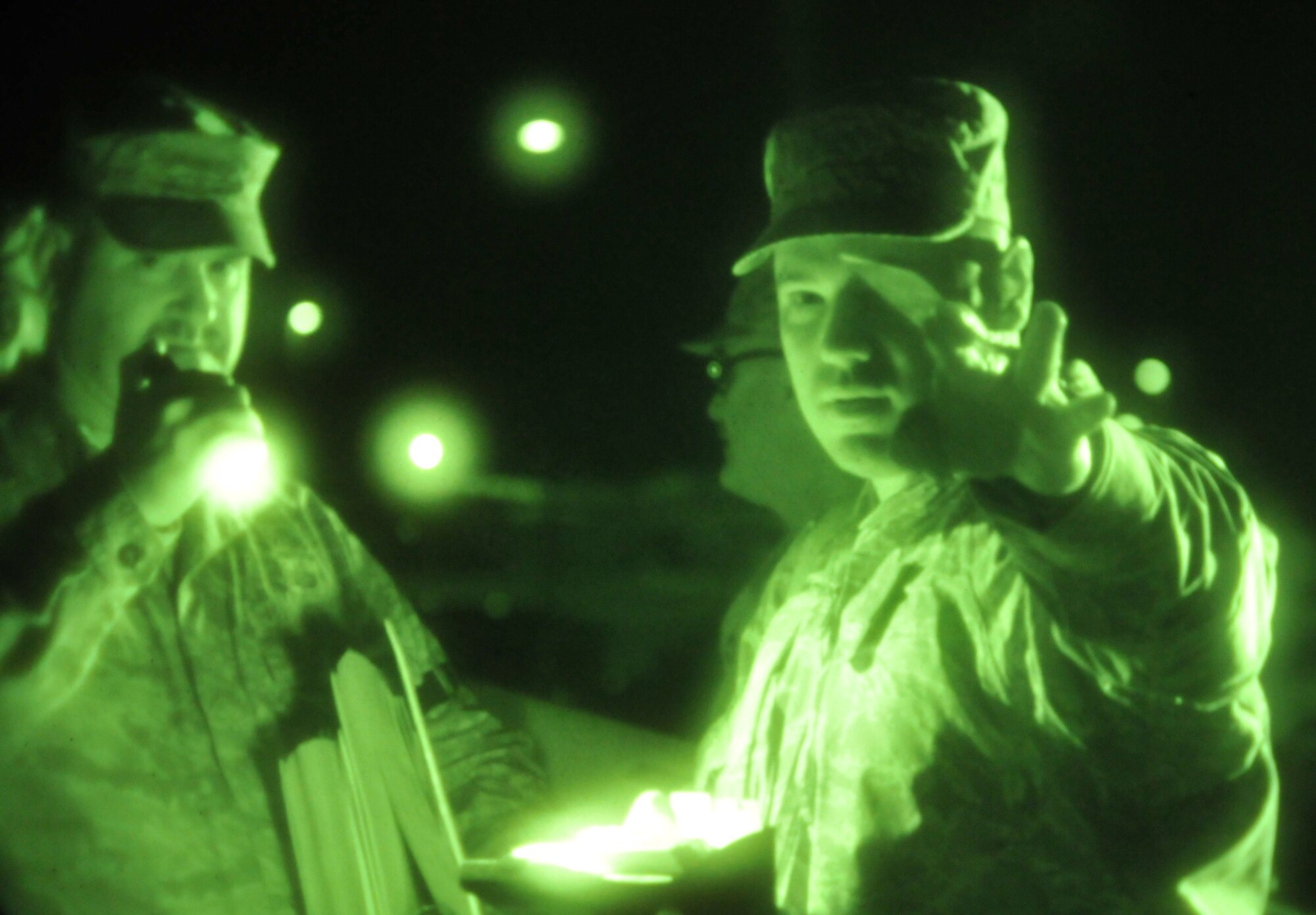 VOLK FIELD ANGB, Wisc., -- Airmen undergoing an operational readiness inspection, hand out identification cards as they test emergency exit procedures. Reservists from Grissom Air Reserve Base, Ind., and Guardsmen from Martinsburg, W.Va., teamed together for the inspection. (U.S. Air Force photo/Master Sergeant Emily Beightol-Deyerle)
