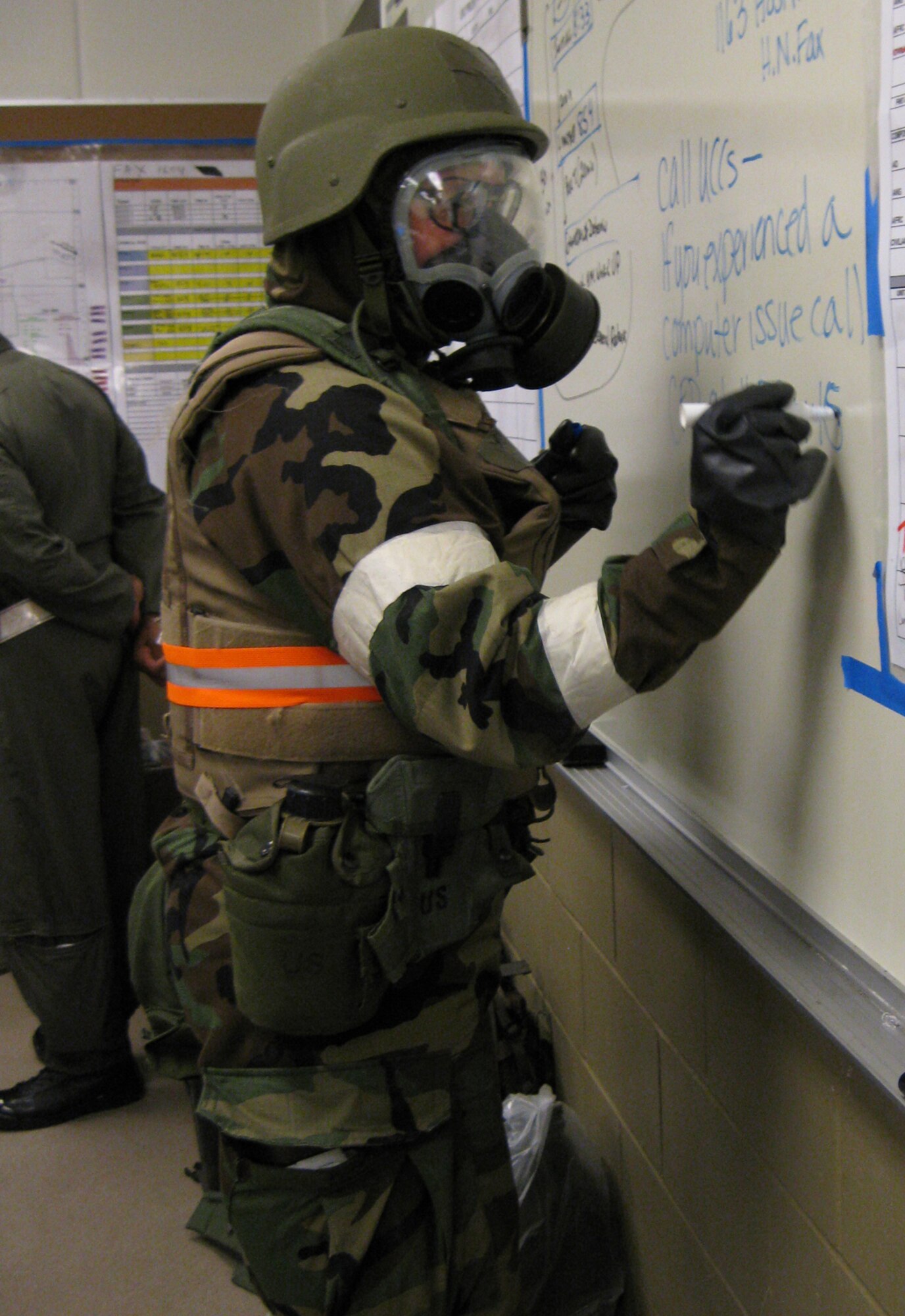 GRISSOM AIR RESERVE BASE, Ind.--, Maj. Rebecca Fox, commander of the 434th Communications Squadron, writes notes while in full mission oriented protective posture gear during a recent operational readiness inspection. (U.S. Air Force photo/ Staff Sgt. Ben Mota)