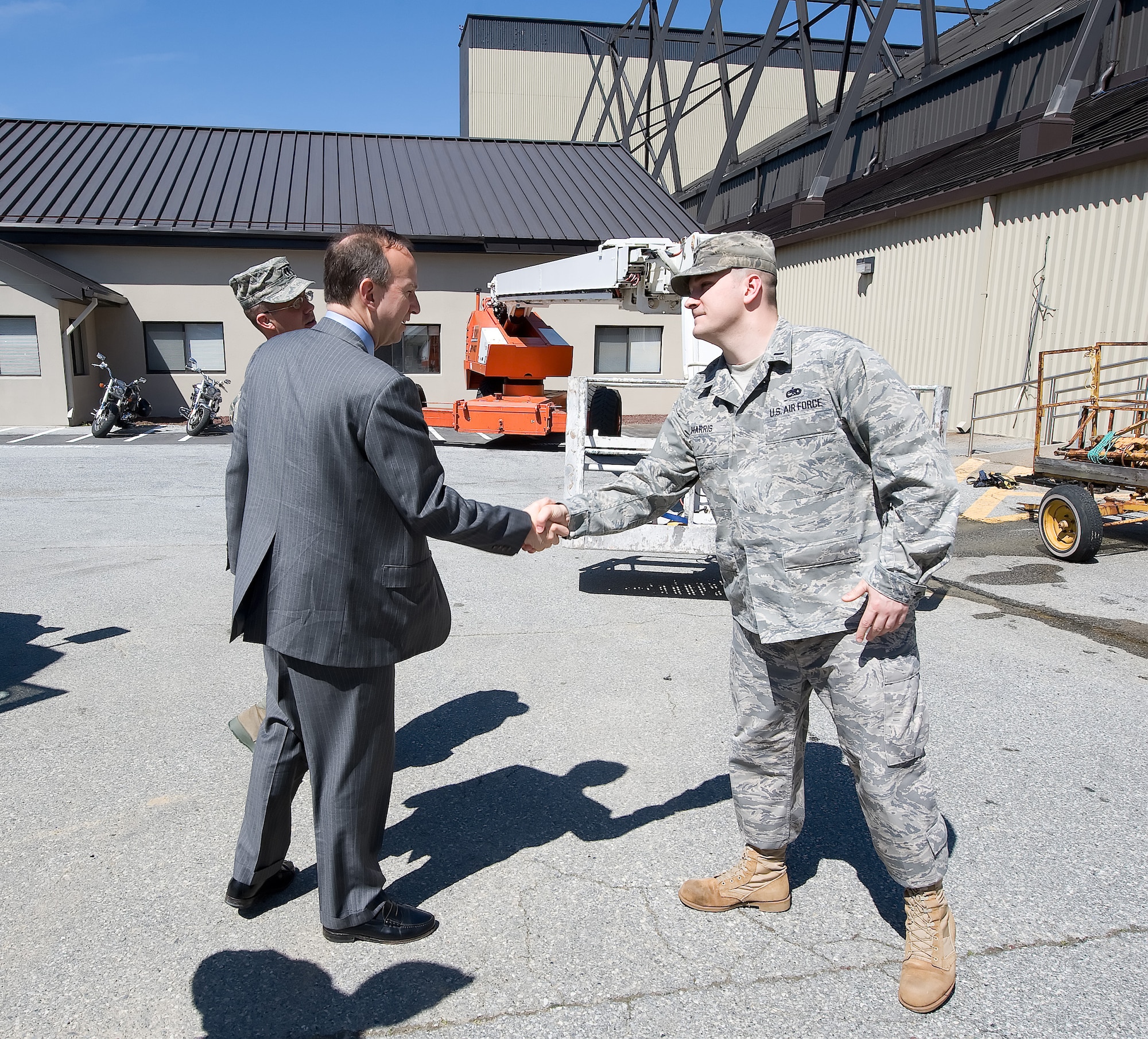 1st Lt. James Harris, 436th Maintenance Squadron, greets Gov. Jack Markell at the ISO Dock before his tour April 1.  (U.S. Air Force photo/Jason Minto)