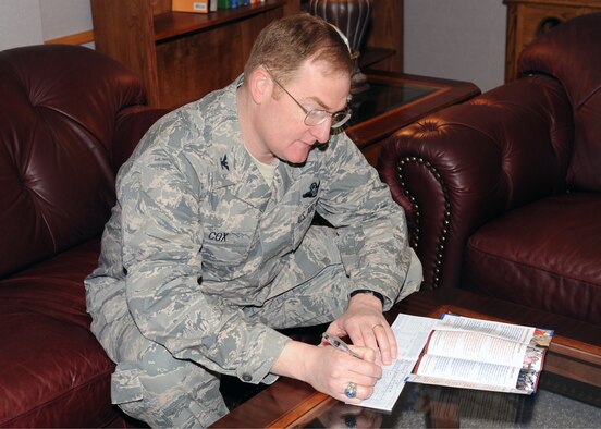 MINOT AIR FORCE BASE, N.D. -- Col. Douglas Cox, 5th Bomb Wing commander, fills out and signs his Air Force Assistance Fund donation paperwork here April 7.  People can contribute to the AFAF through cash, check, money order or payroll deduction to the following organizations: the Air Force Aid Society, the Air Force Enlisted Village, the Air Force Villages and the General and Mrs. Curtis E. LeMay Foundation. (U.S. Air Force photo by Staff Sgt. Keith Ballard)