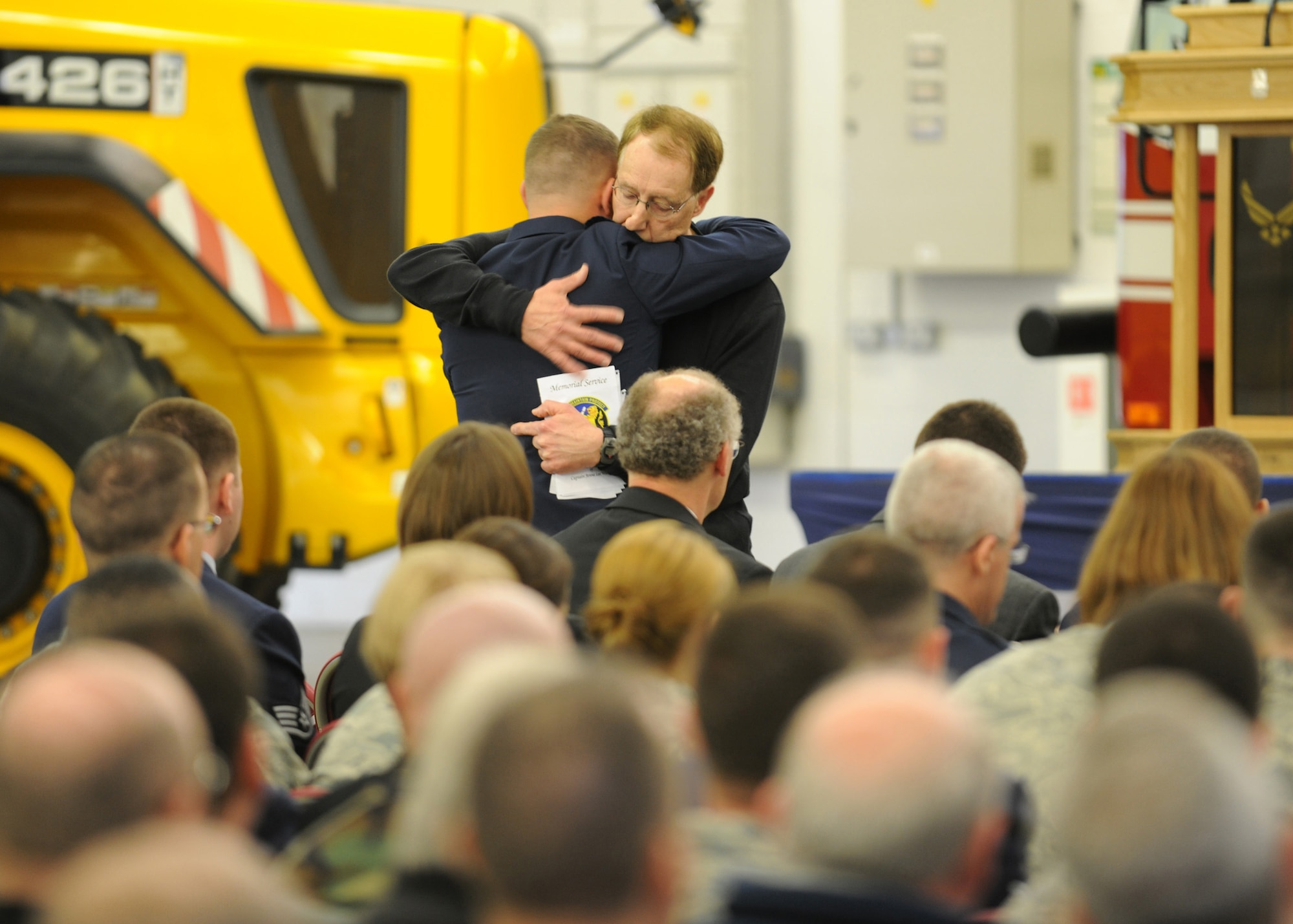 RAF MILDENHALL, England – Peter Sielski, Capt. Jenna Wilcox’s father, hugs his son-in-law during a memorial service for the captain, who died April 1 from injuries sustained in a vehicle-related accident March 27.  Capt. Scott Wilcox and his wife were on vacation in Scotland, both having just returned from Afghanistan, when the tragedy occurred.  (U.S. Air Force photo/Staff Sgt. Jerry Fleshman)