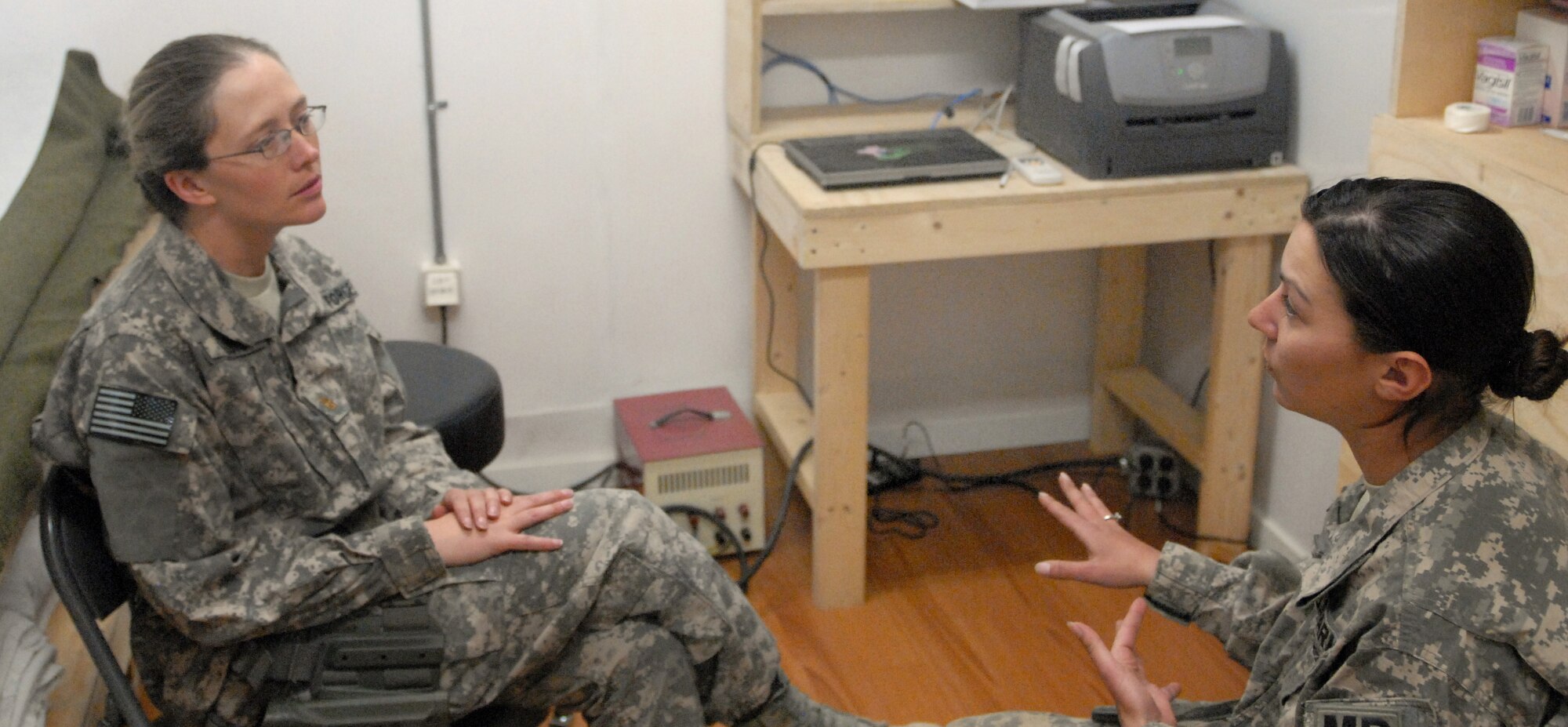PAKTYA PROVINCE, Afghanistan – U.S. Air Force Maj. Kim Floyd, a psychologist with the 92nd Medical Group at Fairchild Air Force Base, Wash., and a native of Ruidoso, N.M., speaks with U.S. Army Spc. Autumn L. Gregg of the 92nd Military Police Company, 95th MP Battalion from Baumholder, Germany, at Forward Operating Base Lightning, Paktya province, Afghanistan, April 1. Floyd, operates out of Camp Goode in Paktya and travels out to eight bases in the province on a regular basis to get to know servicemembers at each base. Their goal is to develop a relationship with as many servicemembers as possible so they have a strong foundation to build on in case they have to tackle more serious issues. (Photo by U.S. Army Sgt. Andrew A. Reagan, 304th Public Affairs Detachment)