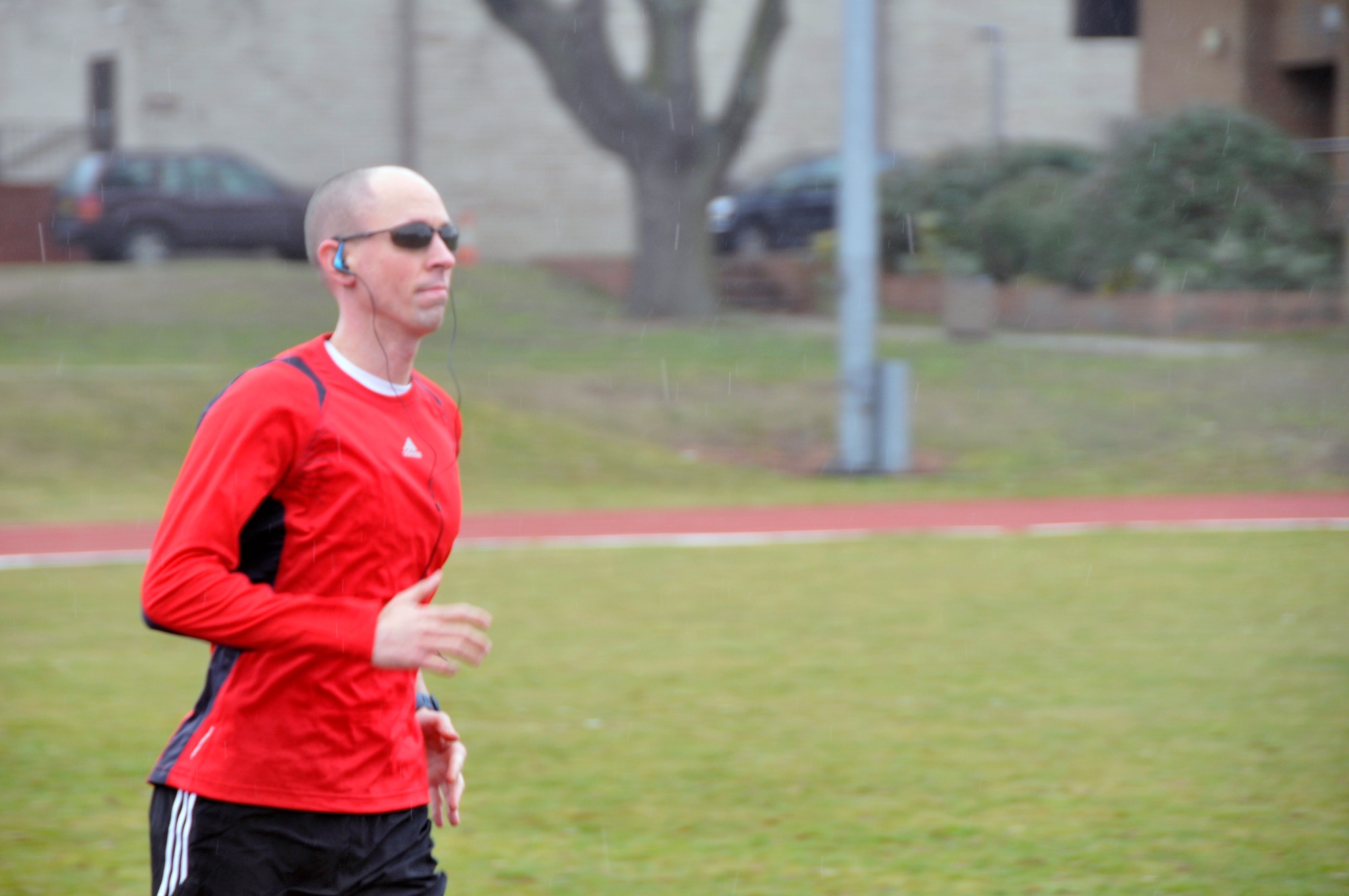 Staff Sgt. Robert Abato, 48th Communications Squadron postal specialist, prepares for the London Marathon by running on the track at RAF Lakenheath, England, March 19. (U.S. Air Force photo/2nd Lt. Ashley Skillman) 
