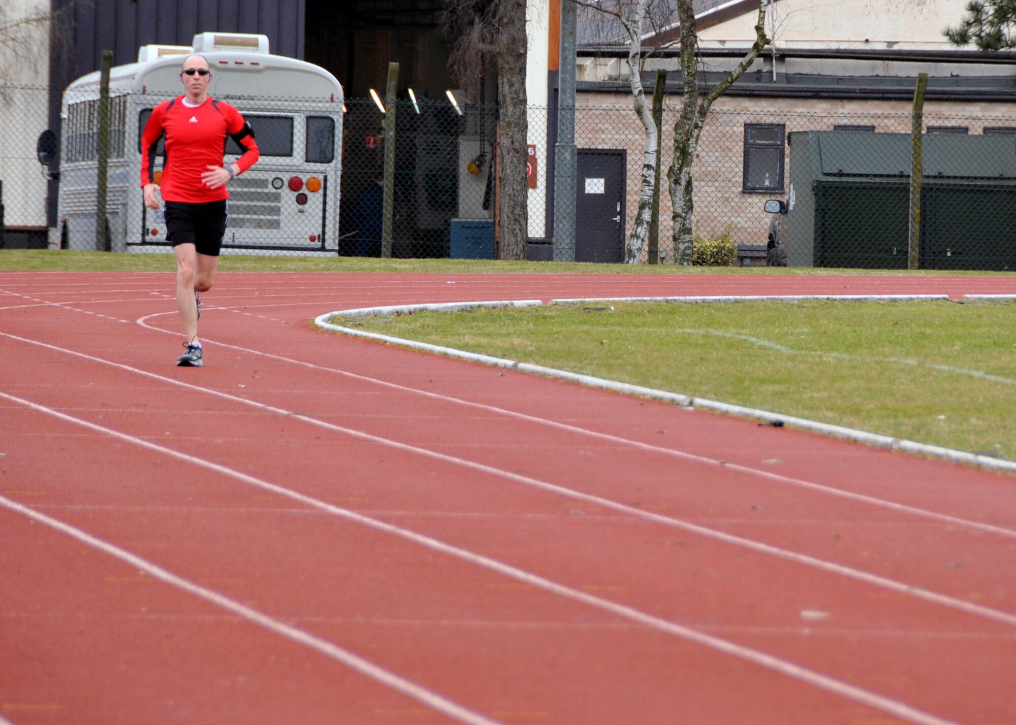 Staff Sgt. Robert Abato, 48th Communications Squadron postal specialist, runs at the track in preparation for the upcoming London Marathon at RAF Lakenheath, England, March 13. (U.S. Air Force photo/2nd Lt. Ashley Skillman)