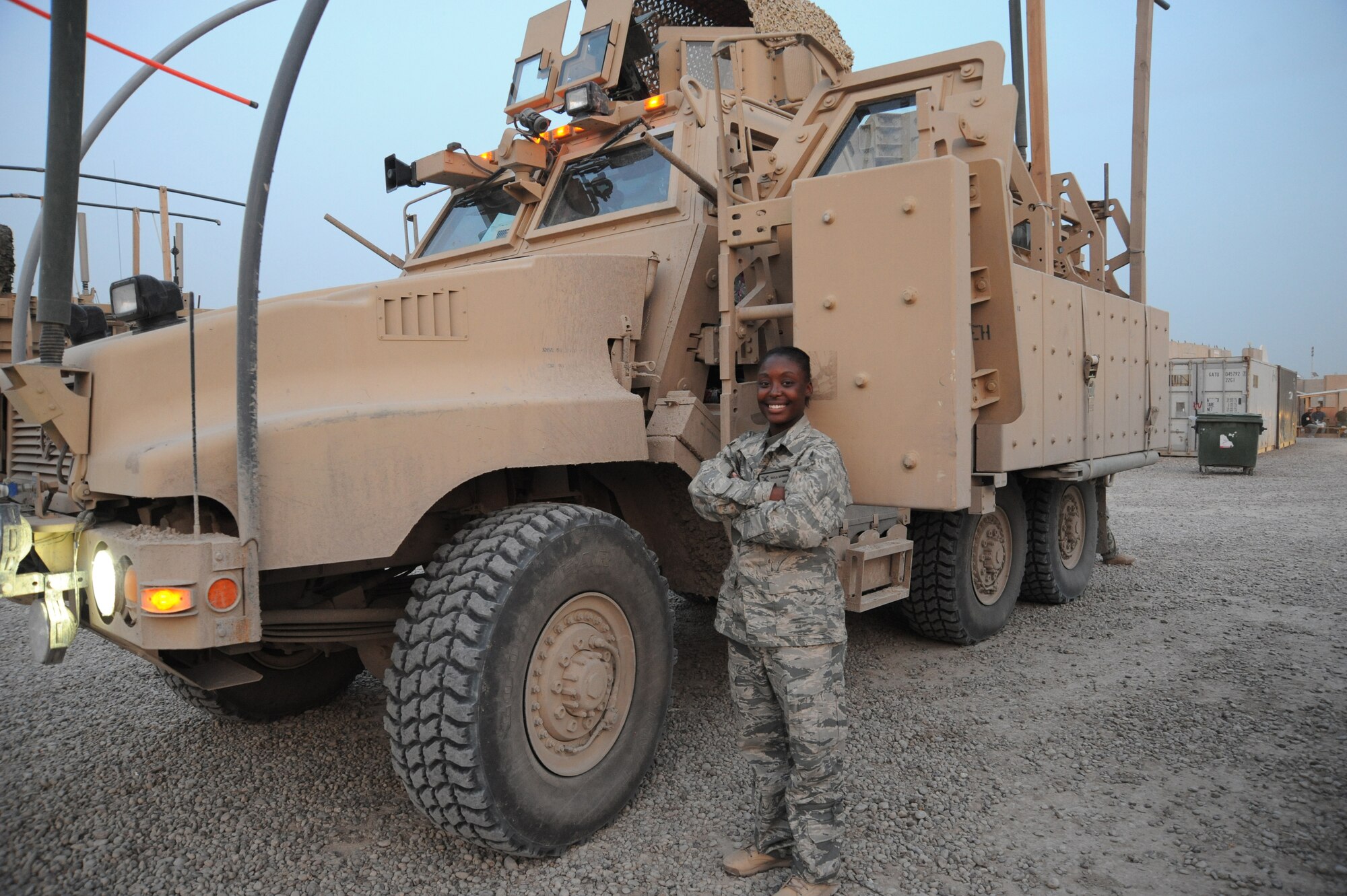 Air Force Senior Airman Kayla Manning, 732d Expeditionary Security Forces Squadron, Detachment 2, stands in front of her Mine Resistant Ambush Protected vehicle after returning from a mission, Camp Stryker, Iraq, April 4, 2010. To enter this life-saving vehicle, Kayla has to place one knee on the Mine Resistant Ambush Protected vehicle steps to hoist her weight upward to climb the remainder of the way into the driver’s cab. Despite a stature of just 5 feet 2 ½ inches, she possess the power, control, and confidence of someone twice her size. (U.S. Air Force photo/Master Sgt. Trish Bunting/Released)