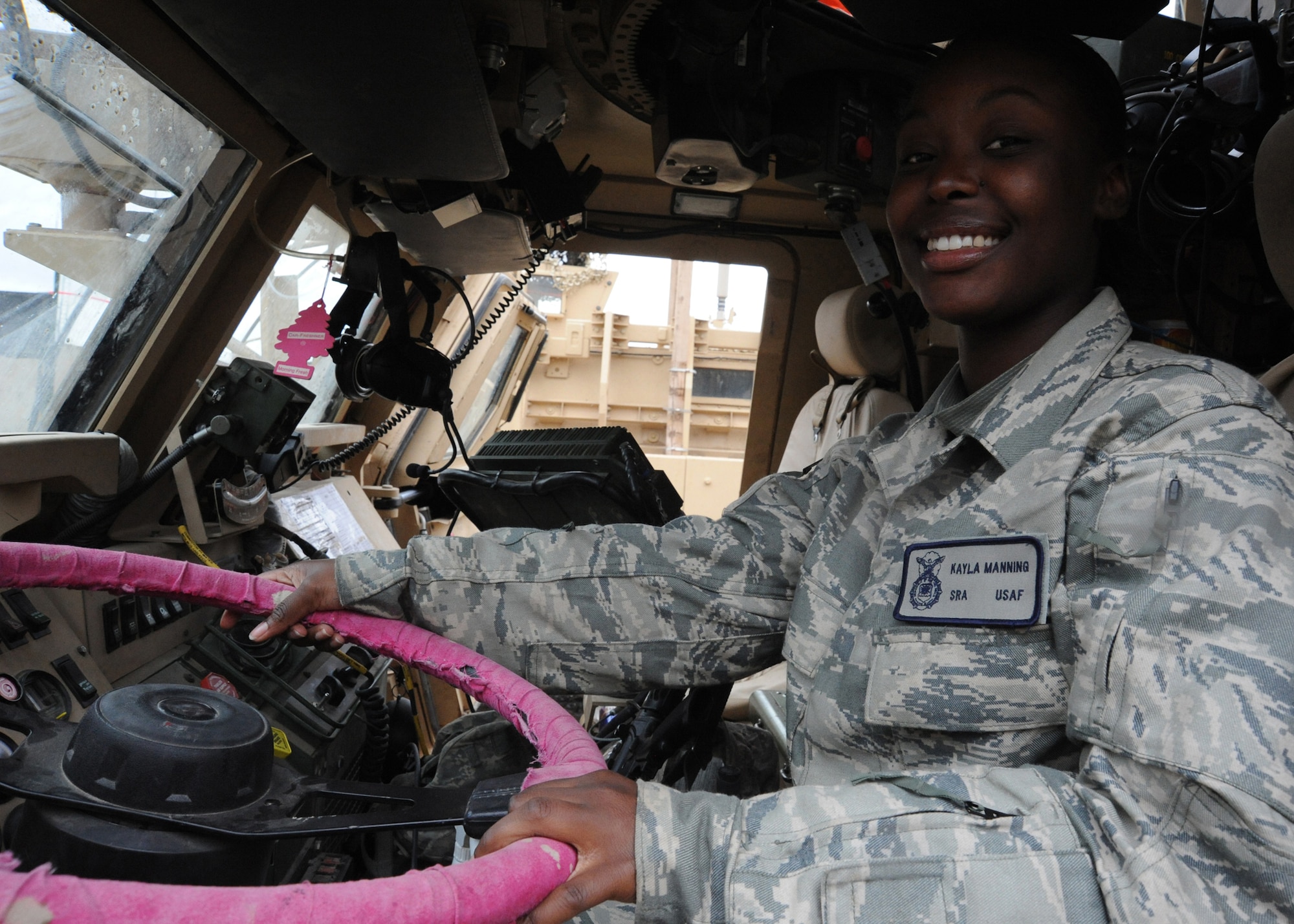 Air Force Senior Airman Kayla Manning, 732nd Expeditionary Security Forces Squadron, Detachment 2, sits at the wheel of her Mine Resistant Ambush Protected vehicle before heading out on a mission, Camp Stryker, Iraq, March 27, 2010. To enter this life-saving vehicle, Kayla has to place one knee on the MRAPs steps to hoist her weight upward to climb the remainder of the way into the driver’s cab. Despite a stature of just 5 feet 2 ½ inches, she possess the power, control, and confidence of someone twice her size. (U.S. Air Force photo/Master Sgt. Trish Bunting/Released)