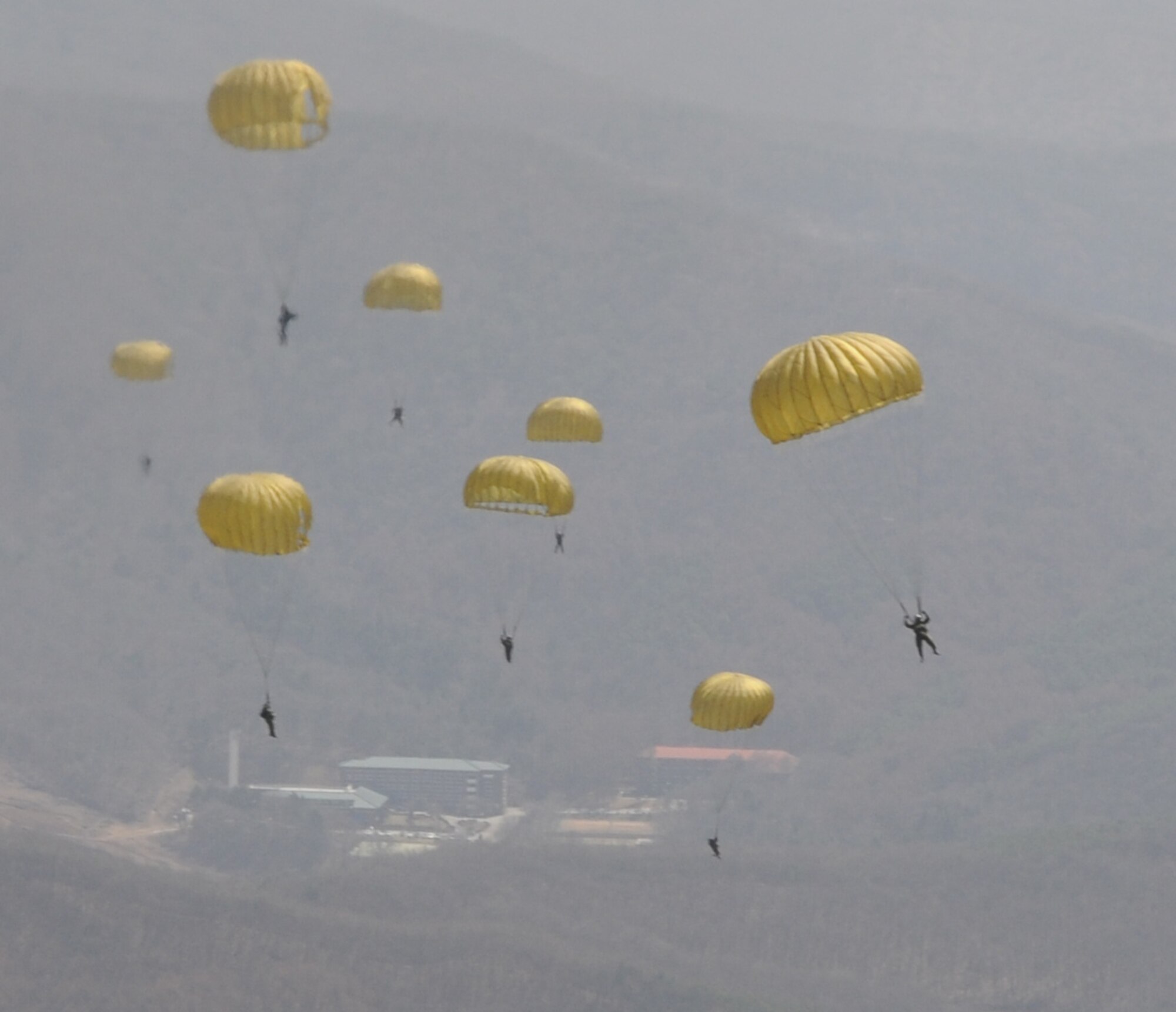 OVER MAE SAN RI, Republic of Korea -- Members of the Republic of Korea Army glide to the ground after a static-line airdrop from a 17th Special Operations Squadron MC-130P Combat Shadow here April 2. More than 70 U.S. and ROK Army soldiers jumped from two MC-130P's as part of a friendship jump between the two armies. (U.S. Air Force photo by Tech. Sgt. Aaron Cram)