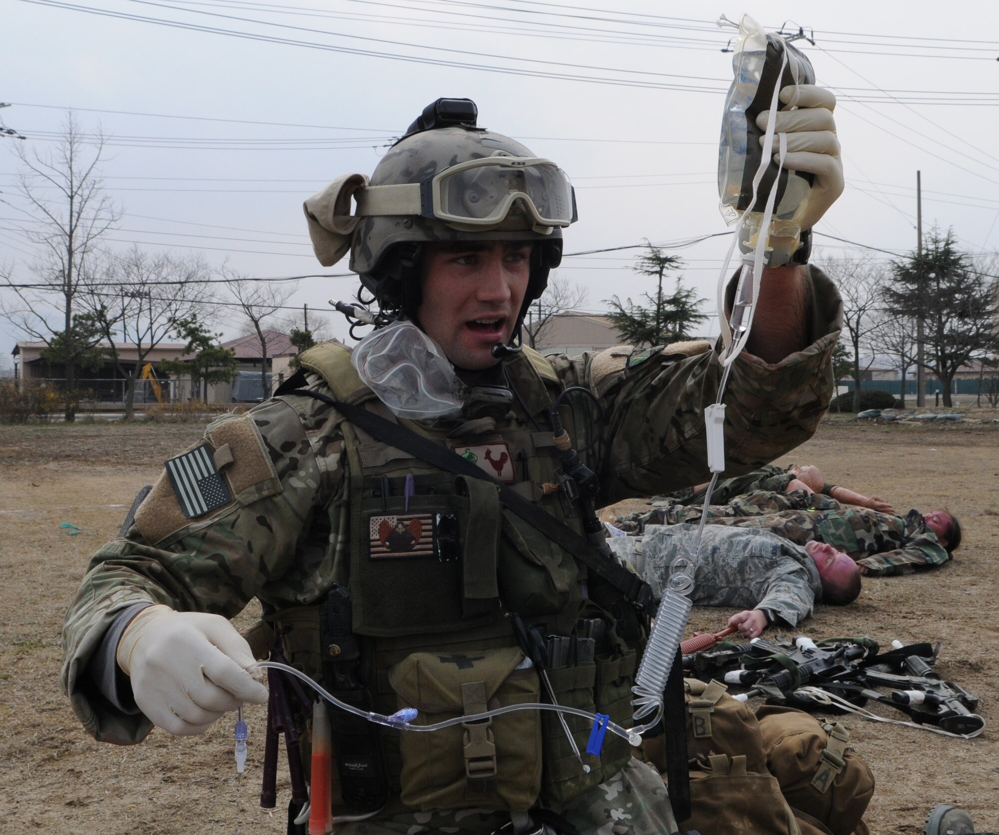 DAEGU AIR BASE, Republic of Korea -- Senior Airman Cody Cerny, a pararescueman from the 320th Special Tactics Squadron, prepares intravenous fluids for a patient during a mass casualty exercise here March 27. The scenario is part of the 353rd Special Operations Group’s annual operational readiness exercise. (U.S. Air Force photo by Tech. Sgt. Aaron Cram)