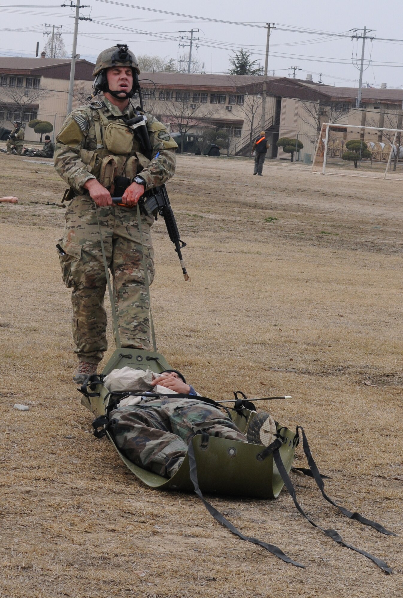 DAEGU AIR BASE, Republic of Korea -- Tech. Sgt. Michael Charvat, a combat controller from the 320th Special Tactics Squadron, drags a simulated wounded soldier to the casualty collection point using a sked stretcher during a mass casualty exercise here March 27. The scenario is part of the 353rd Special Operations Group’s annual operational readiness exercise. (U.S. Air Force photo by Tech. Sgt. Aaron Cram)