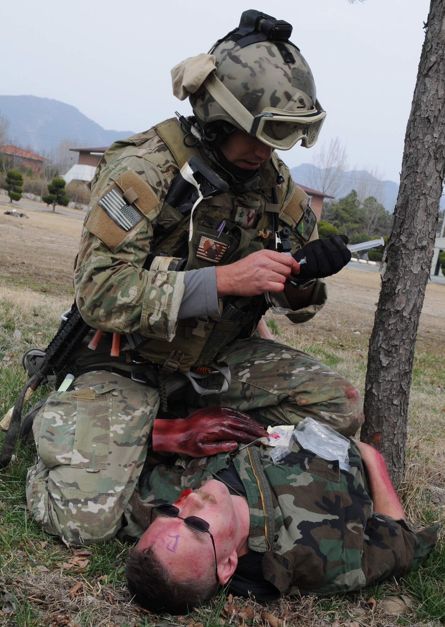 DAEGU AIR BASE, Republic of Korea -- Senior Airman Cody Cerny, a pararescueman from the 320th Special Tactics Squadron, prepares to insert a tube into the neck of a simulated wounded soldier to open an airway during a mass casualty exercise here March 27. The scenario is part of the 353rd Special Operations Group’s annual operational readiness exercise. (U.S. Air Force photo by Tech. Sgt. Aaron Cram)