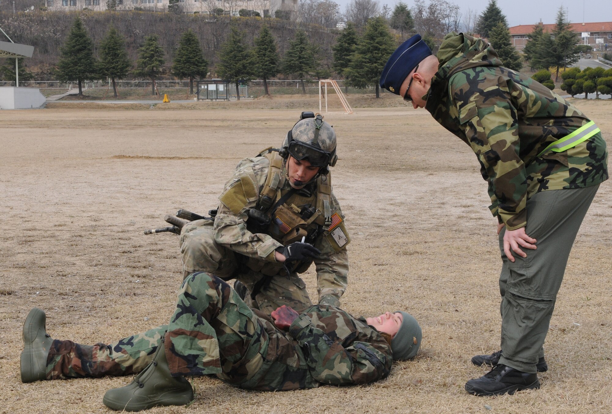 DAEGU AIR BASE, Republic of Korea -- Staff Sgt. Ryan Hatfield, a pararescueman from the 320th Special Tactics Squadron, asks Maj. John Hatfield, a flight surgeon from the 353rd Operations Support Squadron, for the vital signs on a simulated wounded soldier during a mass casualty exercise here March 27. The scenario is part of the 353rd Special Operations Group’s annual operational readiness exercise. (U.S. Air Force photo by Tech. Sgt. Aaron Cram)