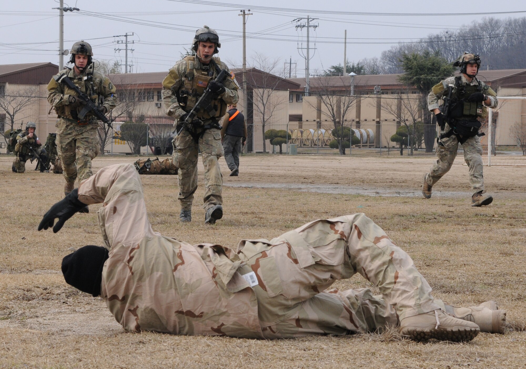 DAEGU AIR BASE, Republic of Korea -- Pararescuemen and a combat controller from the 320th Special Tactics Squadron approach a simulated wounded soldier during a mass casualty exercise here March 27. The scenario is part of the 353rd Special Operations Group’s annual operational readiness exercise. (U.S. Air Force photo by Tech. Sgt. Aaron Cram)