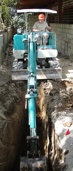 Staff Sgt. Alexander Perez, 18th Civil Engineer Squadron, digs out a trench to install plumbing for an elementary school complex in Northern Luzon, Philippines during Balikatan 2010. Nearly 30 Kadena civil engineers deployed to the Philippines to build two classrooms for the school that was badly damaged by severe weather. The team also enhanced the surrounding buildings by installing modern power lines and clearing out a play yard for the students. (Courtesy photo)