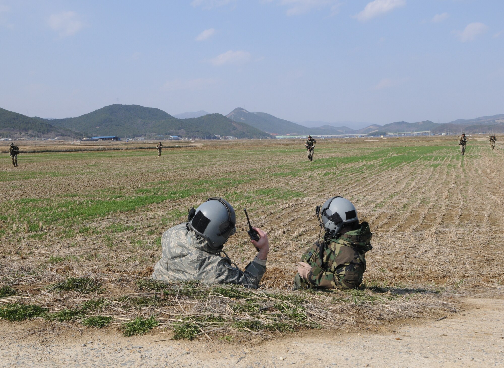 NEAR AN’GANG, Republic of Korea -- Pararescuemen and a combat controller from the 320th Special Tactics Squadron approach simulated wounded aircrew members during a combat search and rescue exercise here March 26. The scenario is part of the 353rd Special Operations Group’s annual operational readiness exercise. (U.S. Air Force photo by Tech. Sgt. Aaron Cram)
