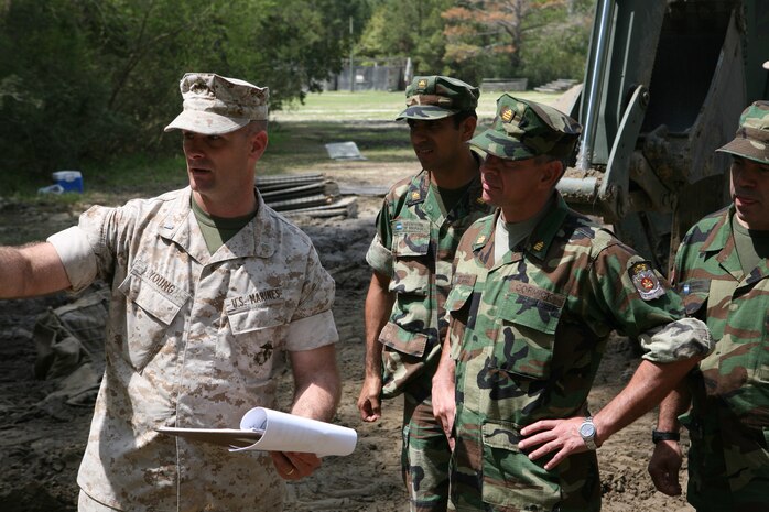 First Lt. Jack M. Young, the executive officer for 8th Engineer Support Battalion, Combat Logistics Regiment 25, 2nd Marine Logistics Group, shows Argentine Marines the combat endurance course aboard Camp Lejeune, N.C., April 8, 2010. The Argentine Marines visited II Marine Expeditionary Force units as part of a theatre engagement program designed to improve military relationships around the world.