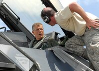 Tech. Sgt. Joshua Stapp, Aircrew Flight Equipment, from the 187th Fighter Wing, Montgomery Alabama, assists, Lee Webber, President and Publisher for The Honolulu Advertiser, with preflight instructions prior to take off, for an incentive flight on a F-16 Falcon, on the flightline, Joint Base Pearl Harbor Hickam, Hawaii, Apr. 7, 2010. (U. S. Air Force photo/Tech. Sgt. Jerome S. Tayborn)