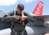 Lee Webber, President and Publisher for The Honolulu Advertiser, checks his flight suit prior to take off for an incentive flight on a F-16 Falcon on the flightline, Joint Base Pearl Harbor Hickam, Hawaii, Apr. 7, 2010. (U. S. Air Force photo/Tech. Sgt. Jerome S. Tayborn)