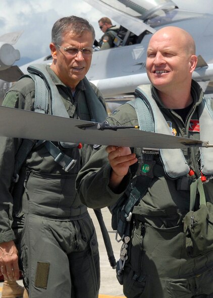 Col. Samuel (Sam) Black, Director of Operations, 100th Fighter Squadron, Air National Guard Alabama, completes his F-16 Falcon preflight checklist, with Lee Webber, President and Publisher, for The Honolulu Advertiser, prior to takeoff on the flightline, Joint Base Pearl Harbor Hickam, Hawaii, Apr. 7, 2010. (U. S. Air Force photo/Tech. Sgt. Jerome S. Tayborn)