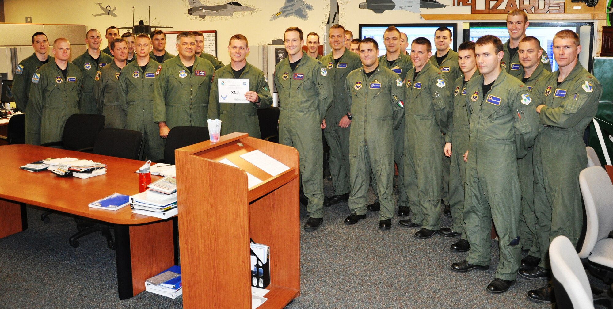 LAUGHLIN AIR FORCE BASE, Texas – 1st Lt. Dominic Teich, 87th Flying Training Squadron, poses with fellow members of his squadron after being presented the XLer of the Week award by Col. Jeffrey McDaniels, 47th Flying Training Wing commander, April 7. (U.S. Air Force photo by Airman 1st Class Blake Mize)