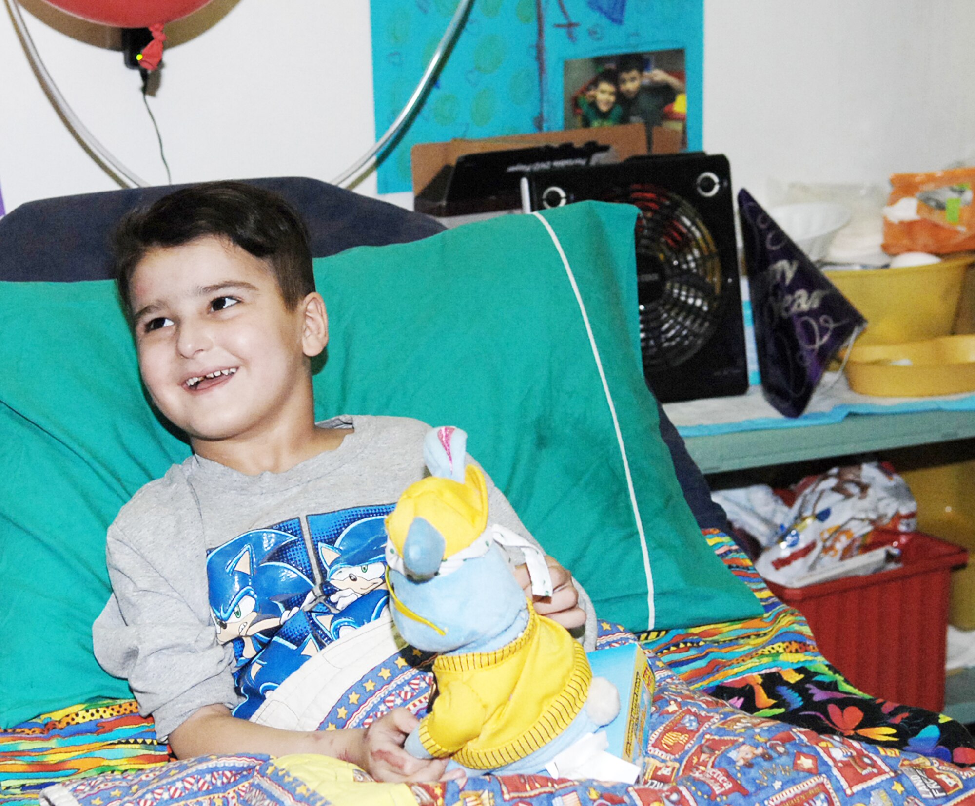 Six-year-old Sajad Hany Shaker Mahmud, a survivor of an improvised explosive device attack, laughs as he plays with a birthday gift April 1, 2010, at the Air Force Theater Hospital in Iraq. Sajad celebrated his 6th birthday while recovering at the Air Force Theater Hospital. He received multiple presents and birthday wishes from the medical staff who have taken care of him during his 72-day stay at the hospital. (U.S. Air Force photo/Airman 1st Class Allison M. Boehm)