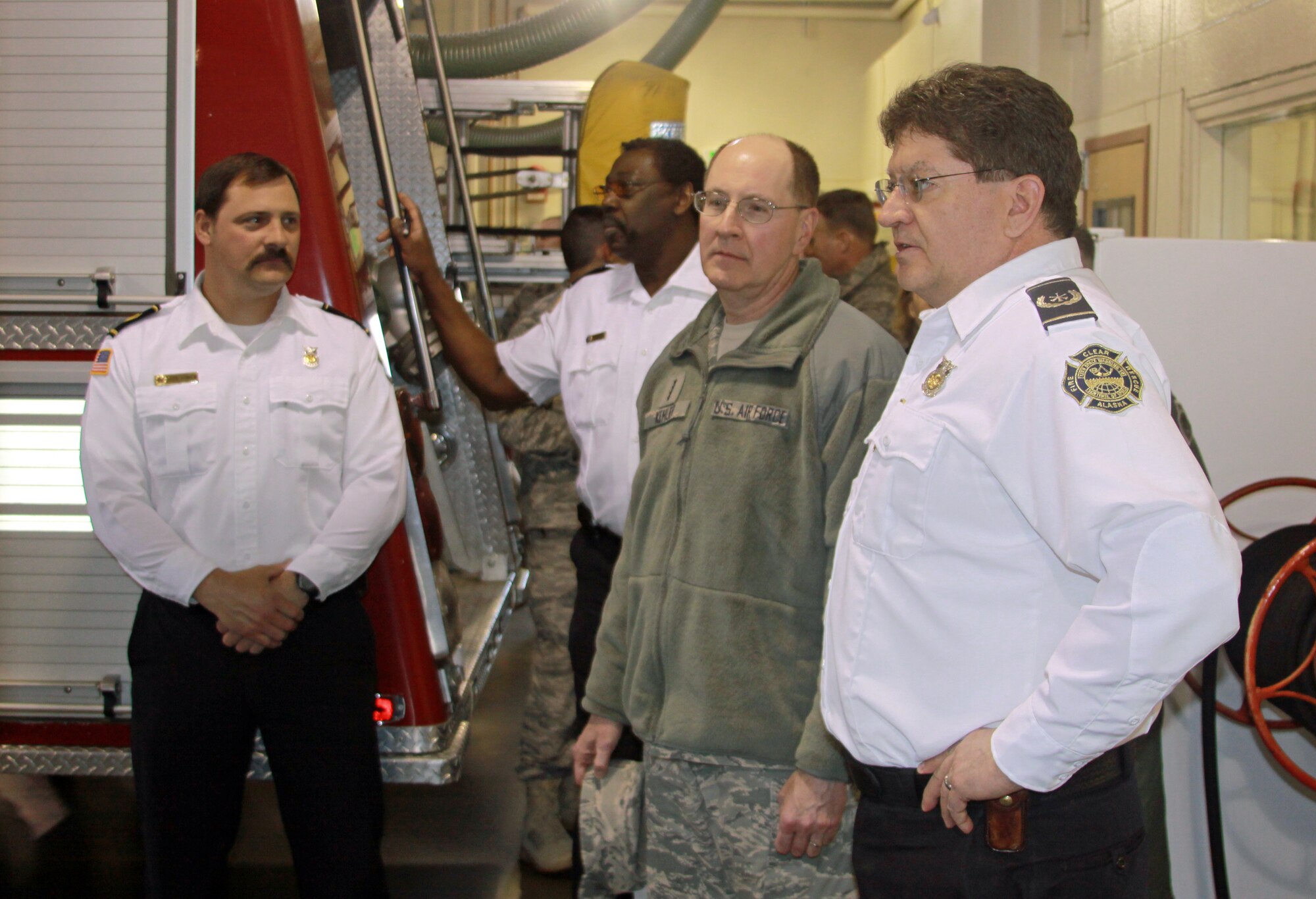 CLEAR AIR FORCE STATION, Alaska – Berry Corbin (right), 13th Space Warning Squadron assistant fire chief, discusses first responder capabilities with Gen. C. Robert Kehler, Air Force Space Command commander, during a tour of the fire station while West Brinkley, 13th SWS fire chief (second from left) and David Conklin (left), 13th SWS Fire Department training officer, look on. General Kehler visited the 13th SWS from March 28 to 29.  Clear AFS is one of six installations supported by the 21st Space Wing. (U.S. Air Force photo/Tech. Sgt. Michael Reyor)   