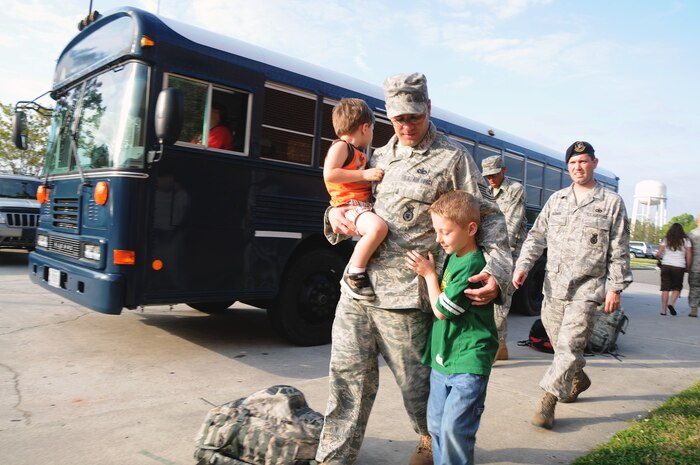 Tech. Sgt. Randall Fontenot walks next to his son Zach with his son Lucas in his arms April 8, 2010, at Joint Base Charleston, S.C., before boarding a bus bound for Charleston International Airport. Sergeant Fontenot, along with two deploying teams of Airmen with the 628th Security Forces Squadron, departed the base for training in preparation to deploy to the Middle East. Sergeant Fontenot is a flight chief with the 628 SFS and a team leader with the deploying group of Airmen. (U.S. Air Force photo/Staff Sgt. Daniel Bowles)