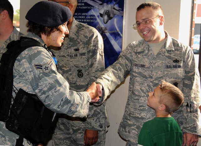 Tech. Sgt. Randall Fontenot wishes fellow squadron member Airman 1st Class Mary Boyd goodbye before boarding his bus bound for Charleston International Airport April 8, 2010, at Joint Base Charleston, S.C. Sergeant Fontenot and a team of approximately 30 Airmen with the 628th Security Forces Squadron departed the base to conduct air base defense training prior to their deployment in late April. Sergeant Fontenot is a flight chief with 628 SFS, and Airman Boyd is an installation entry controller. (U.S. Air Force photo/Staff Sgt. Daniel Bowles)