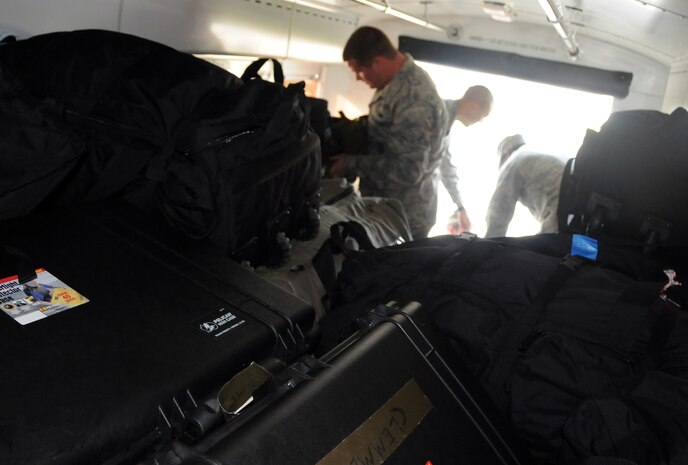 Airmen with the 628th Security Forces Squadron pile equipment into a bus bound for Charleston International Airport April 8, 2010, at Joint Base Charleston, S.C. After loading up their gear, the Airmen departed the base to make their flight to Fort Wolters, Texas, for training in preparation for deployment in late April. (U.S. Air Force photo/Staff Sgt. Daniel Bowles)