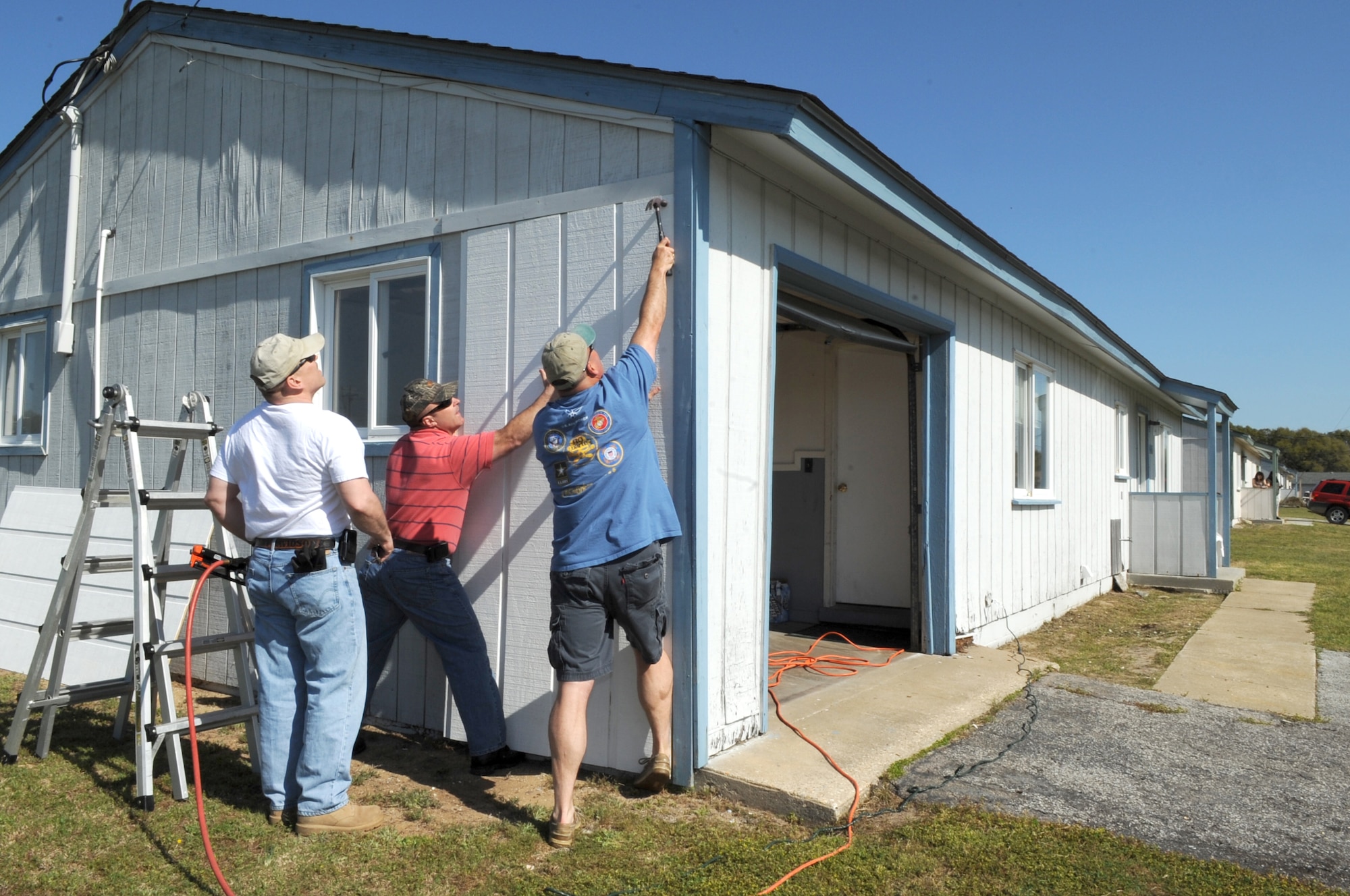 FORT FISHER RECREATION AREA, N.C -- Volunteers from Seymour Johnson Air Force Base nail new siding onto cottages here, April 7, 2010. Before it closed in the late 1980's, Fort Fisher was an Air Force radar complex. (U.S. Air Force photo/Staff Sergeant Courtney Richardson)