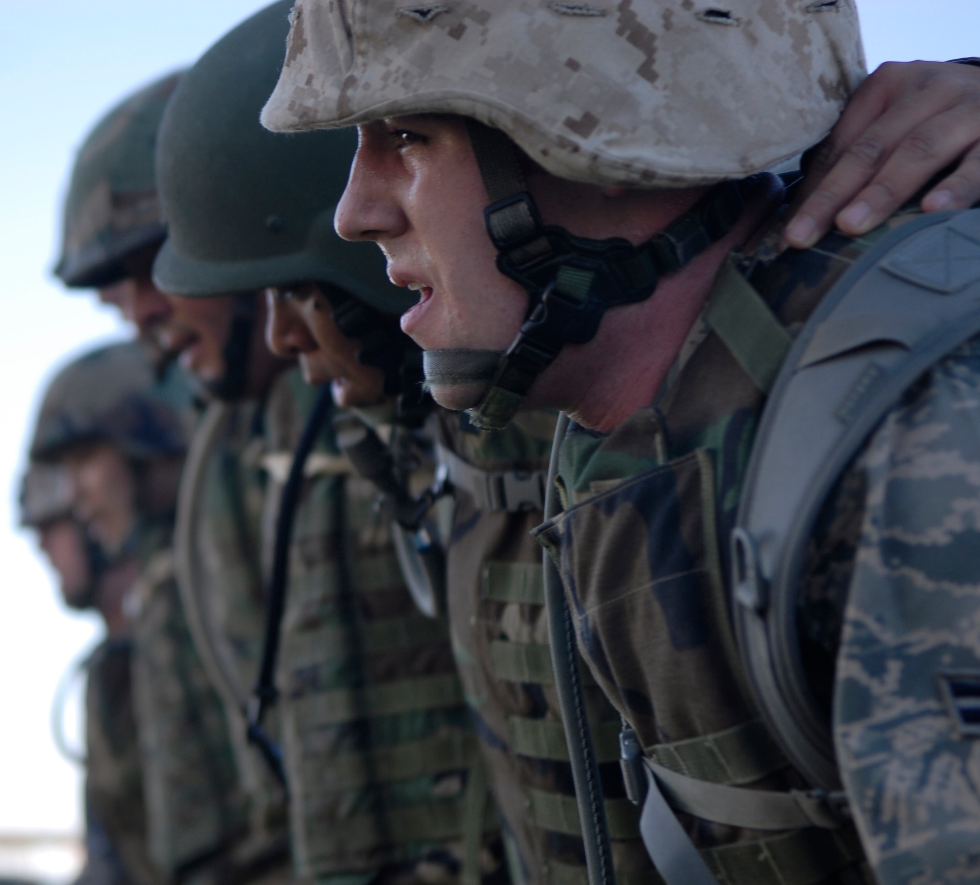 Airman 1st Class Eric Gentry, 56th Component Maintenance Squadron avionics apprentice, calls out "down" to give the command to lunge forward in unison during a military combative training course at Luke Air Force Base, Ariz., April. 7. Airman Gentry was picked as class leader by combative training course instructor U.S. Marine Corp. Staff Sgt. Gardy Sylvain, Training chief staff NCO.  (U.S. Air Force photo by Airman 1st Class Ronifel Yasay) 