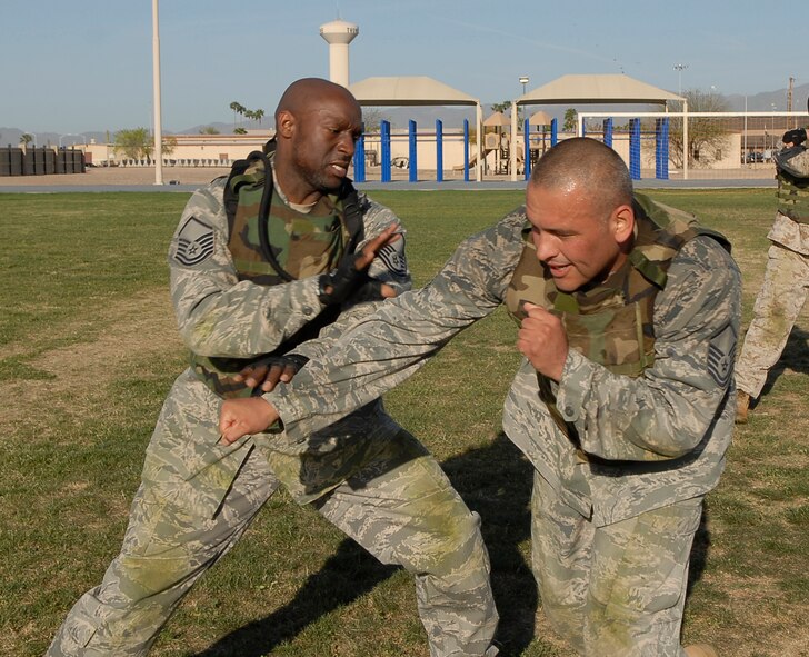 Master Sgt. Glen Presswood, 61st Aircraft Maintenance Unit support flight chief, counters Master Sgt. Donaciano Salinas', 56th Medical Support Squadron flight chief of information systems office NCOIC, punch during a military combative training course taught by U.S. Marine Corp. Staff Sgt. Gardy Sylvain, Training chief staff NCO, after a run around Luke Air Force Base, Ariz., April 5. Participants of this course started April 1st and will complete their training by April 23rd.  (U.S. Air Force photo by Airman 1st Class Ronifel Yasay)