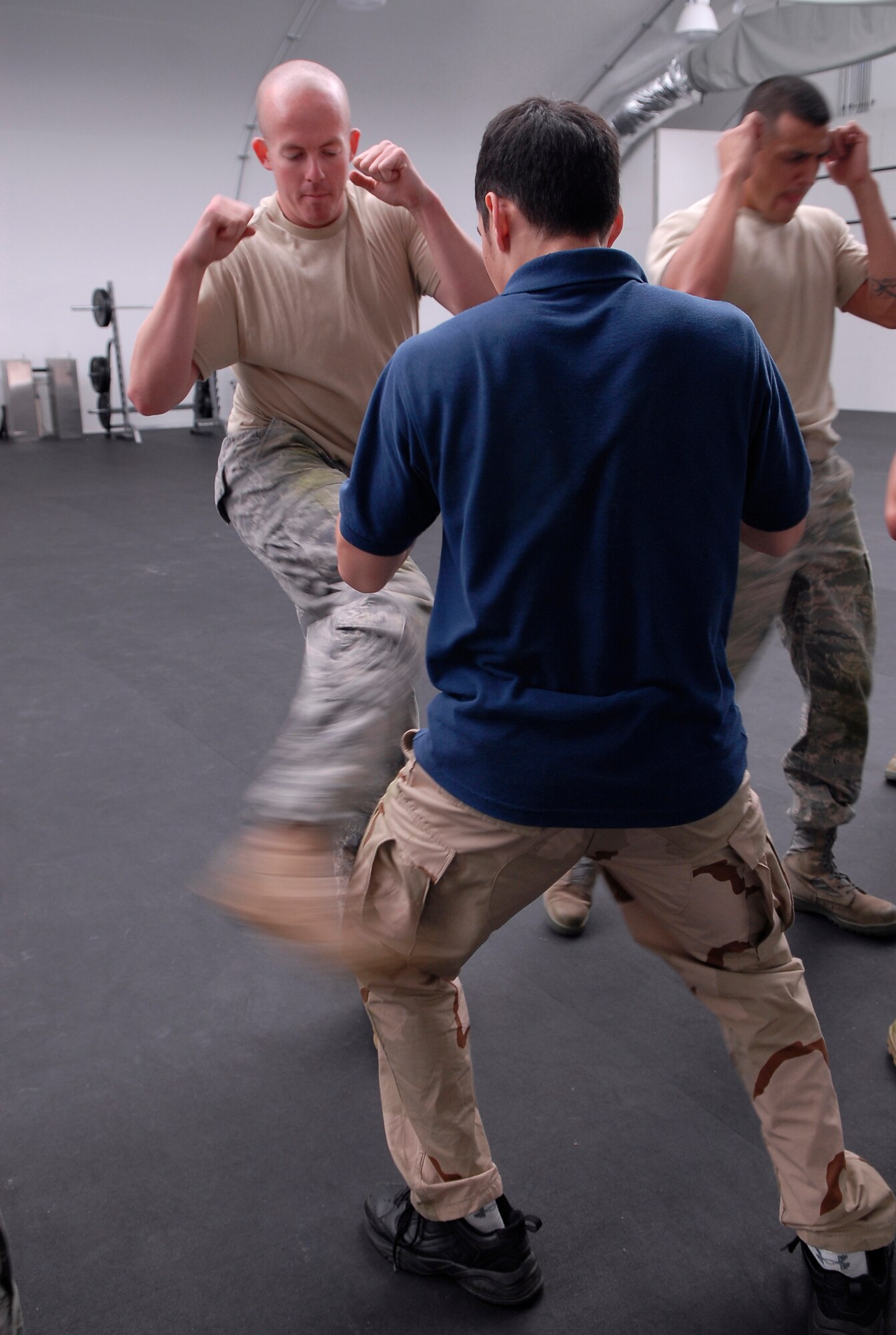 Staff Sgt. Ryan Cobb, 56th Communications Squadron airfield systems technician, kicks Matthew Corcoran, 56th Force Support Squadron CrossFit Luke group instructor, in an exercise called "body hardening" in which the individual's body adjusts to getting hit at the Combat PT Center at Luke Air Force Base, Ariz., April 5 during a military combative training course. U.S. Marine Corp. Staff Sgt. Gardy Sylvain, USMC training chief staff NCO, teaches the combative training course which lasts from Apr. 1st to the 23rd.  (U.S. Air Force photo by Airman 1st Class Ronifel Yasay) 