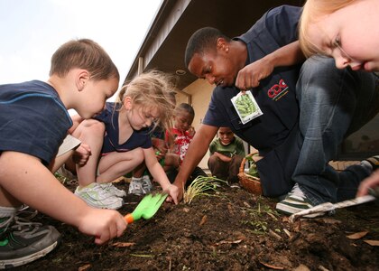 Children from the Lackland child development center plant their spring gardens April 1. Lackland's child development program was recently named the best in the Air Force. (U.S. Air Force photo/Robbin Cresswell)