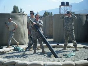 FORWARD OPERATING BASE MEHTAR LAM, Afghanistan -- Staff Sgt. Jessica Williams, 633d Medical Group Mental Health Flight, loads a mortar in preparation for a launch. WIlliams is currently deployed to Afghanistan, serving in combat stress care. (Courtesy photo)