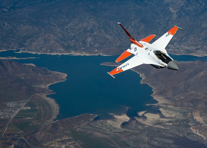 An F-16 Fighting Falcon fitted with radio frequency identification tags flies behind a NKC-135 test tanker on an aerial flight test April 7.  The mission is to test out the Automatic Receiver Aircraft Identification system on the KC-135.  Air Force photo by Chad Bellay