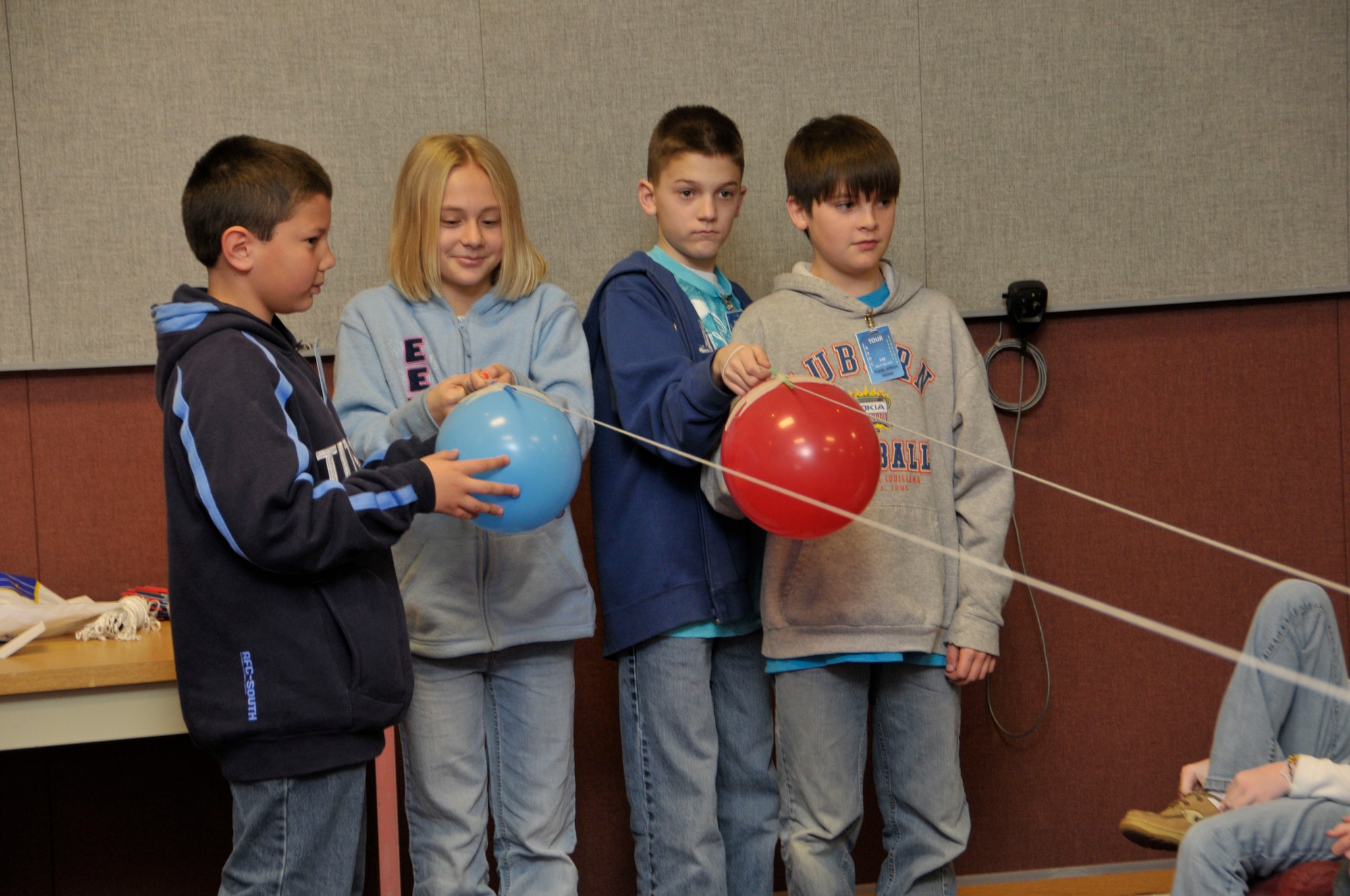 Fifth grade enrichment students from Cowan and Broadview elementary schools in Franklin County conduct an experiment to determine how drag can affect an object’s speed during a base tour March 31. (Photo by Rick Goodfriend)