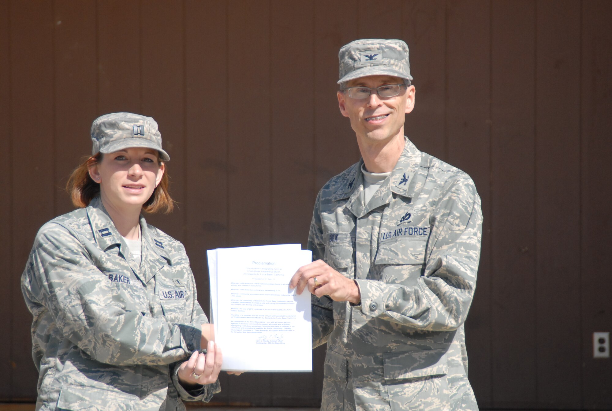 Capt. Sarah Baker, Family Advocacy Officer, 95th Medical Operation’s Squadron, receives the base’s proclamation from Col. David Bek, Individual Mobilization Augmentee for the commander, 95th Air Base Wing, at Edwards kick-off of April’s National Child Abuse Prevention Month on April 1st.  Air Force photograph by Stephen K. Robinson