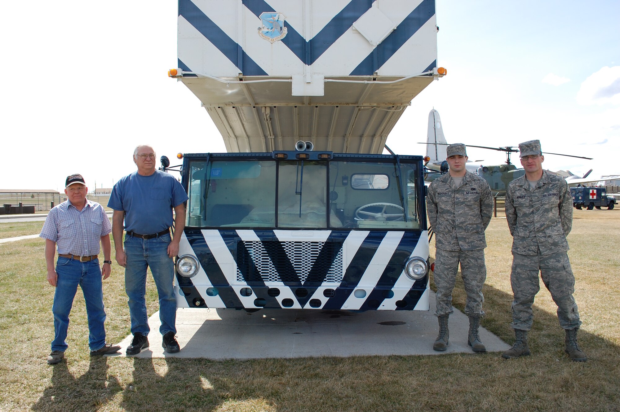 The four individuals who are responsible for the restoration of this 1962 transporter erector are, left to right, Dave Marzolf, Rex Jewitt, Senior Airman Shane McDonald and Senior Airman Bryan Seybold. (U.S. Air Force photo/Valerie Mullett)