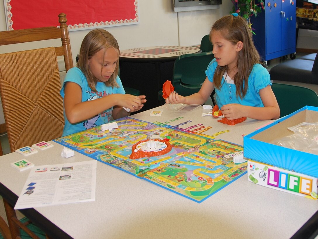 Jessika Collie, 11 (left) and Jaelyn Derrickson, 9, play the game Life at Patrick’s School Age Program during their spring break from school. The SAP is open for children 5 to 12 years old and was recently given the Counsel on Accreditation stamp of approval for meeting national standards for operating school age programs. (U.S. Air Force photo/Tech. Sgt. Tom Czerwinski)