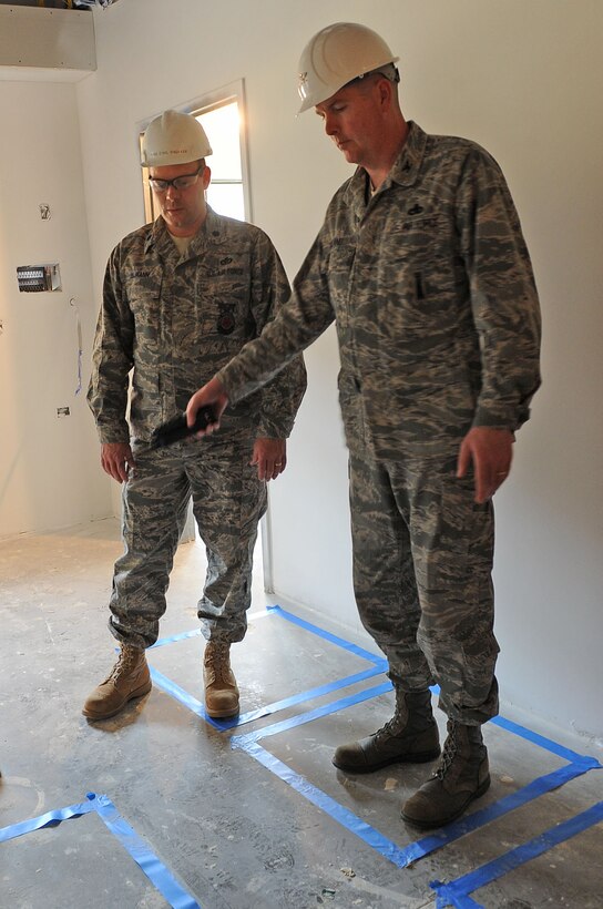 LANGLEY AIR FORCE BASE, Va. -- Col. Donald Kirkland, 633d Air Base Wing commander, and Lt. Col. Jeffery Ullmann, 633 Civil Engineer Squadron commander, discuss furniture floor plans for a future Airman dormitory during the Base Civil Engineer Update Project Tour March 7. 633 CES is constructing and improving multiple facilities base-wide. (U.S. Air Force photo/Airman Rebecca Montez)
